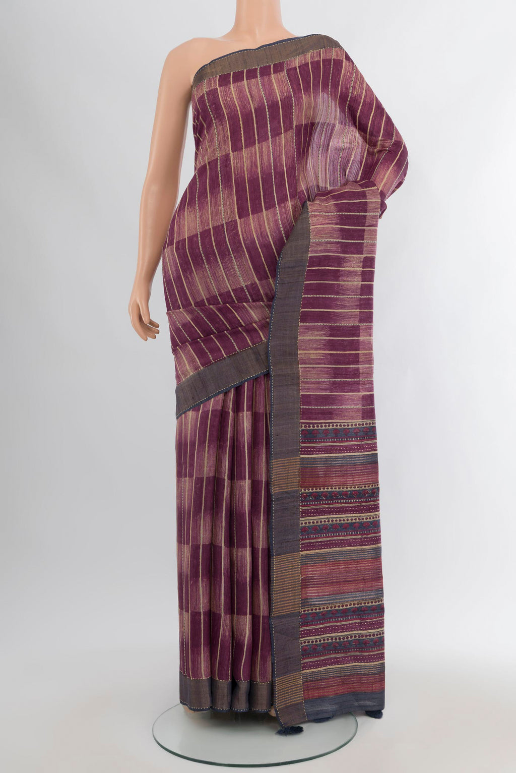 Purple Tussar Silk Saree with Printed design on the body and Zari Border.  displayed on a mannequin