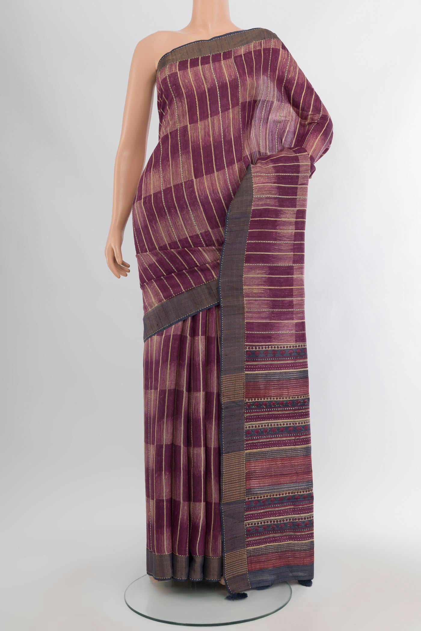 Purple Tussar Silk Saree with Printed design on the body and Zari Border.  displayed on a mannequin