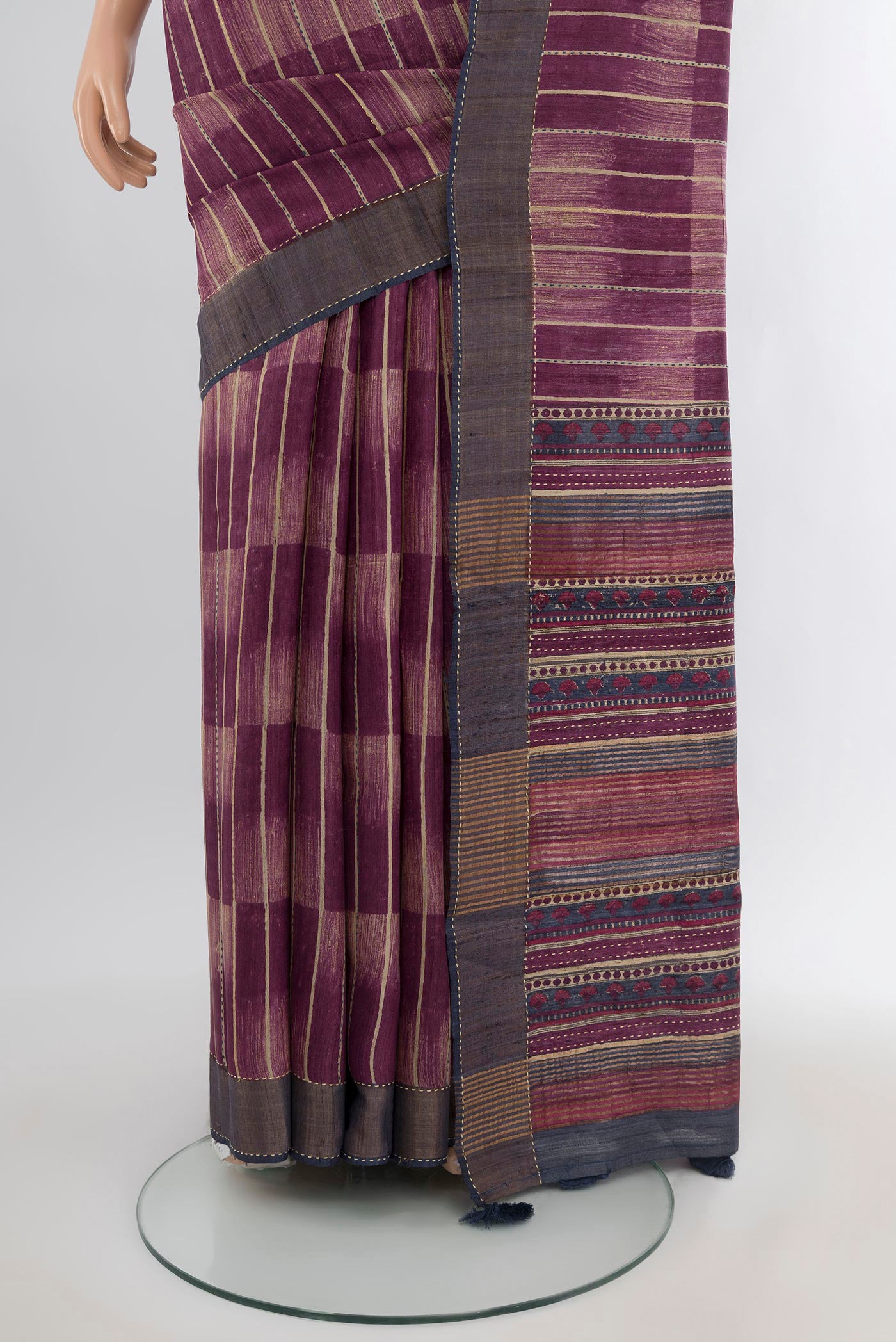 Pleats and pallu of Purple Tussar Silk Saree with Printed design on the body and Zari Border. 