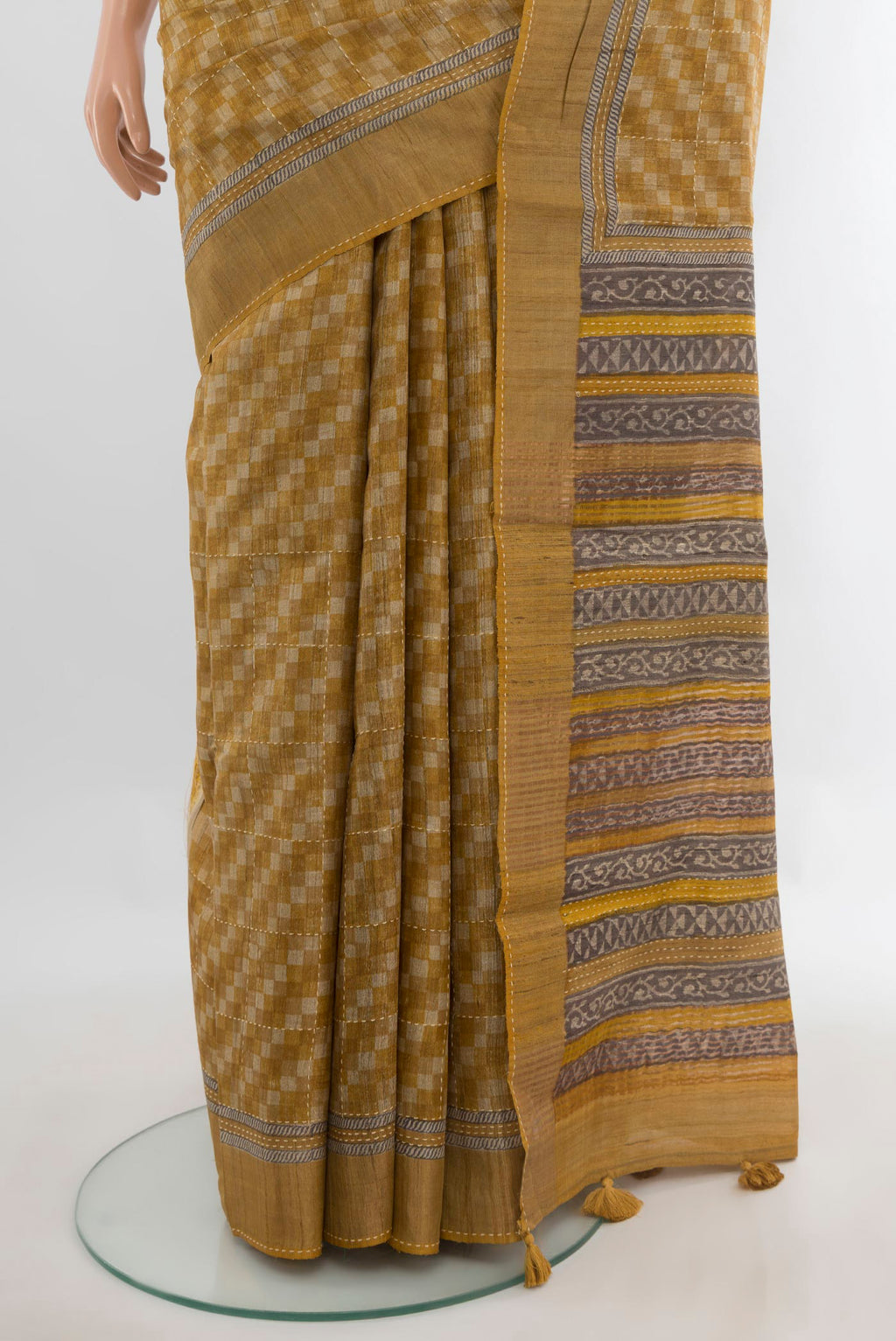 Pleats and pallu of Mustard Tussar Saree with Embroidery on the body and Zari Border. 