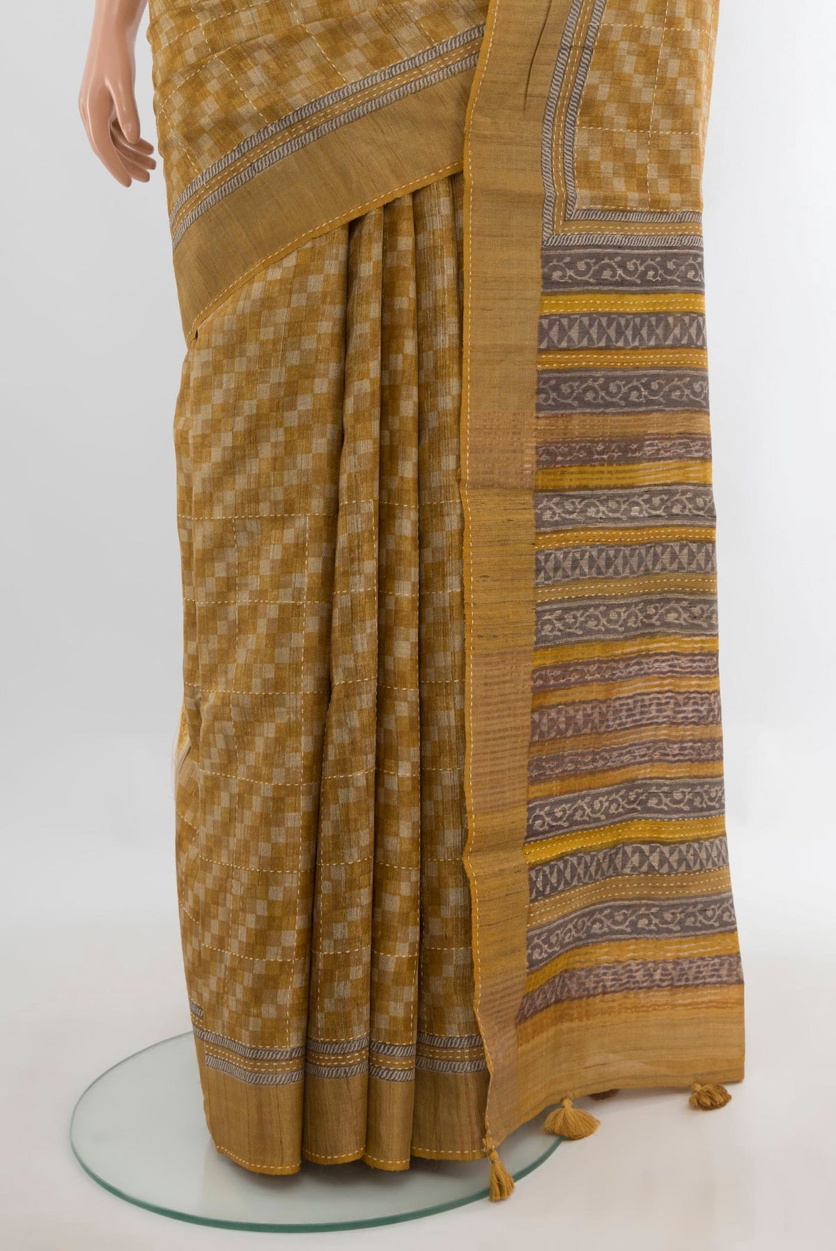 Pleats and pallu of Mustard Tussar Saree with Embroidery on the body and Zari Border. 