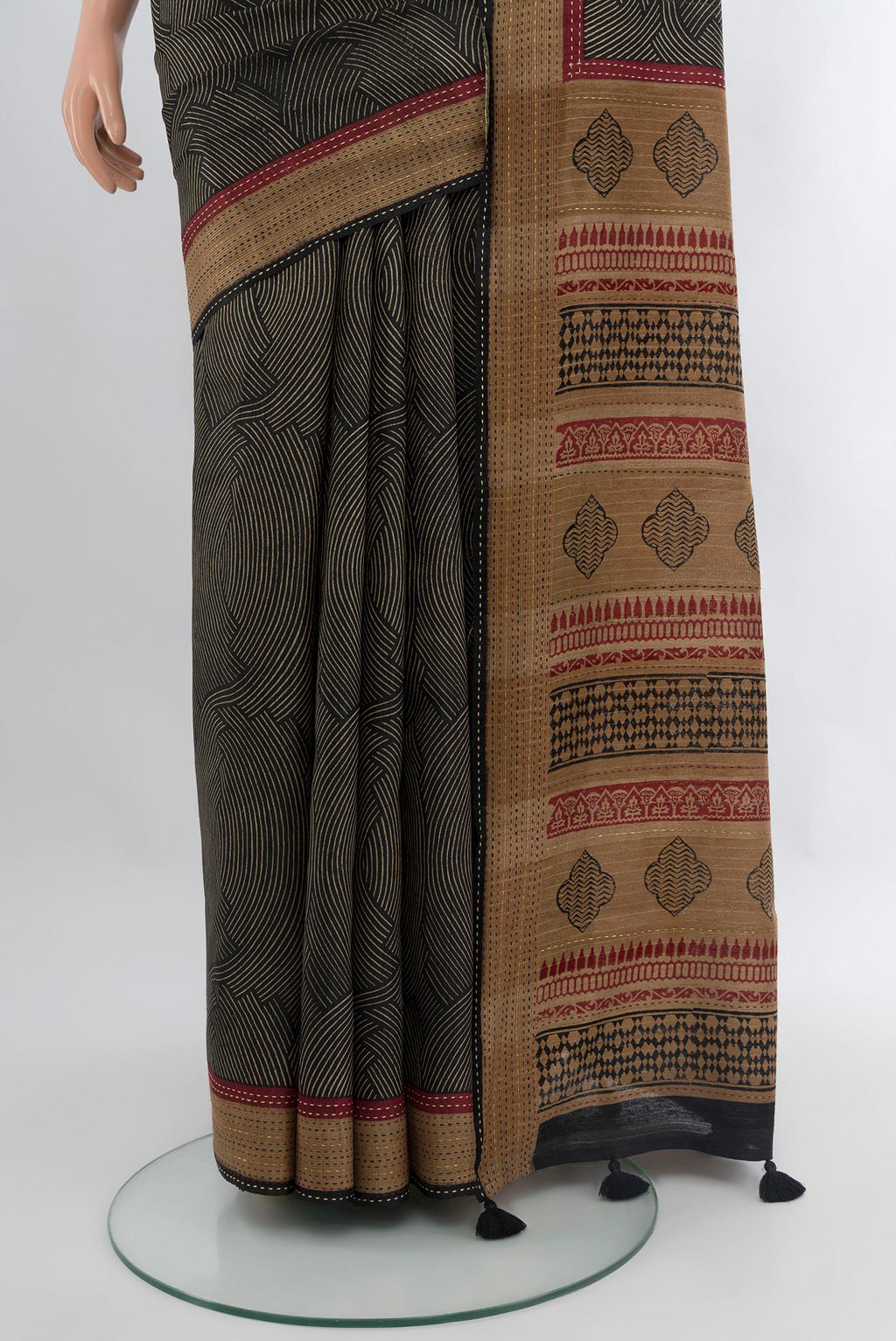 Pleats and pallu of Black Tussar Silk Saree with Printed design on the body and Thread Border. 