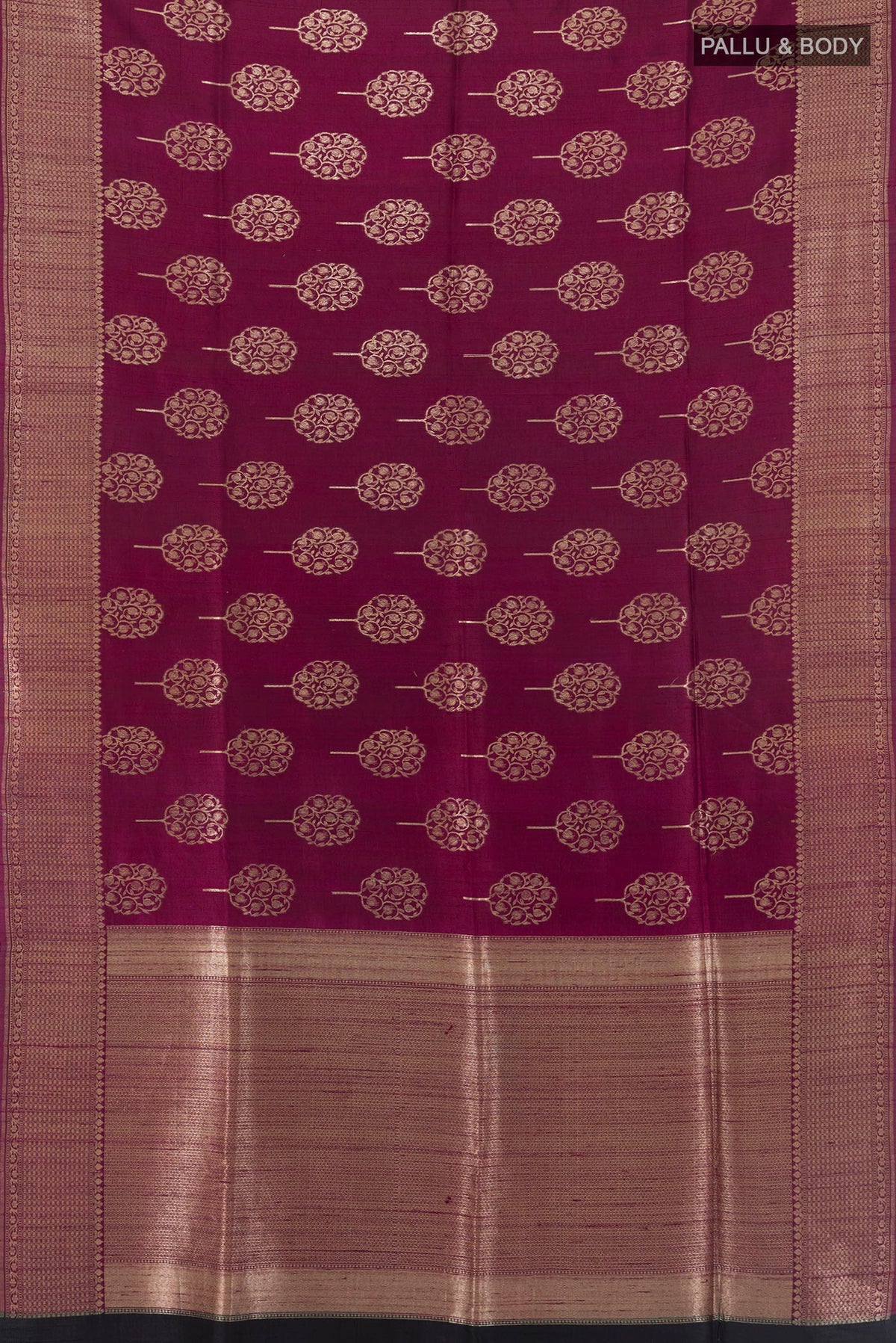 Flat view of Magenta Tussar Saree with Zari Butta on the body and Zari Border. 
