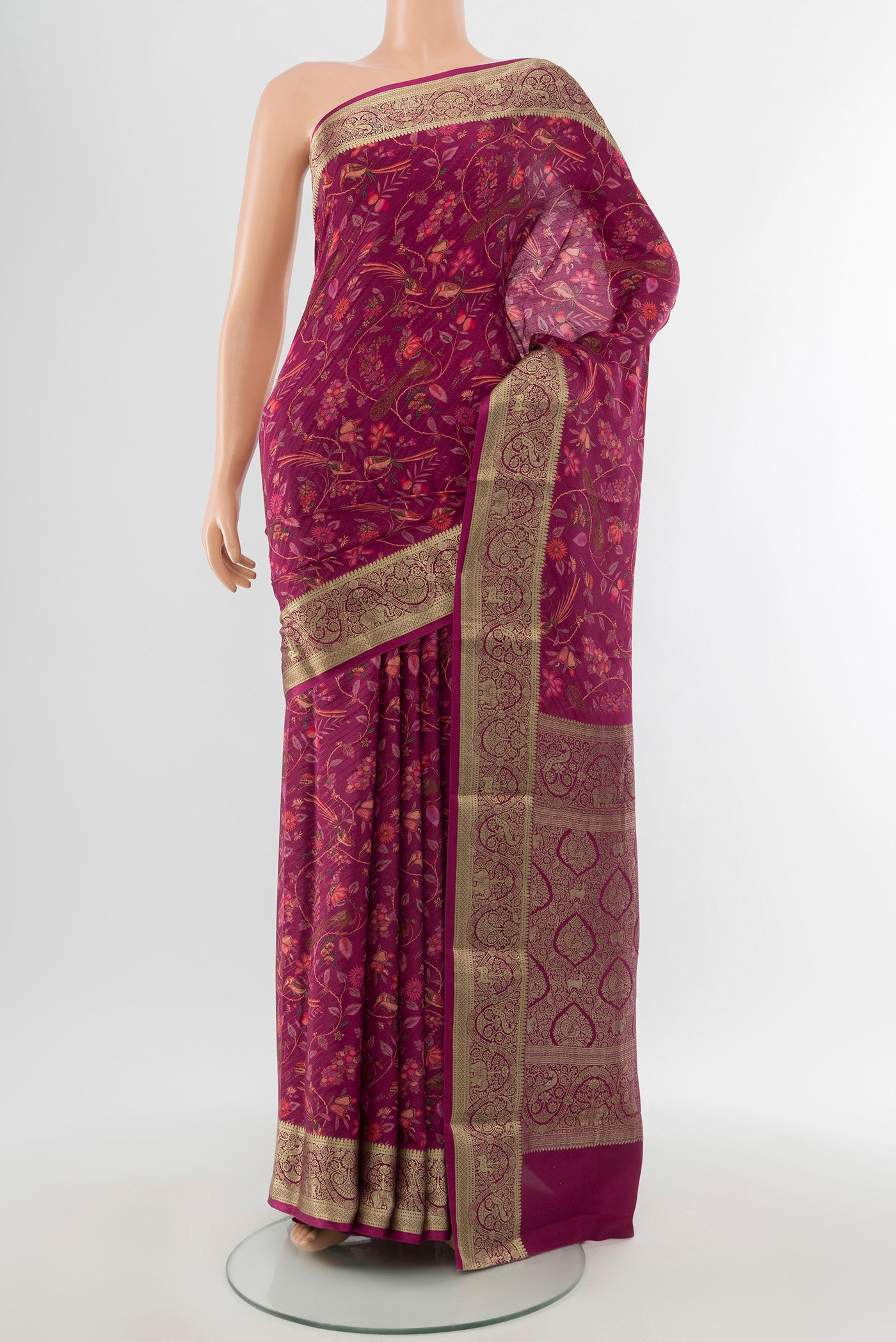 Magenta Crepe Saree with Floral Print on the body and Zari Border.  displayed on a mannequin