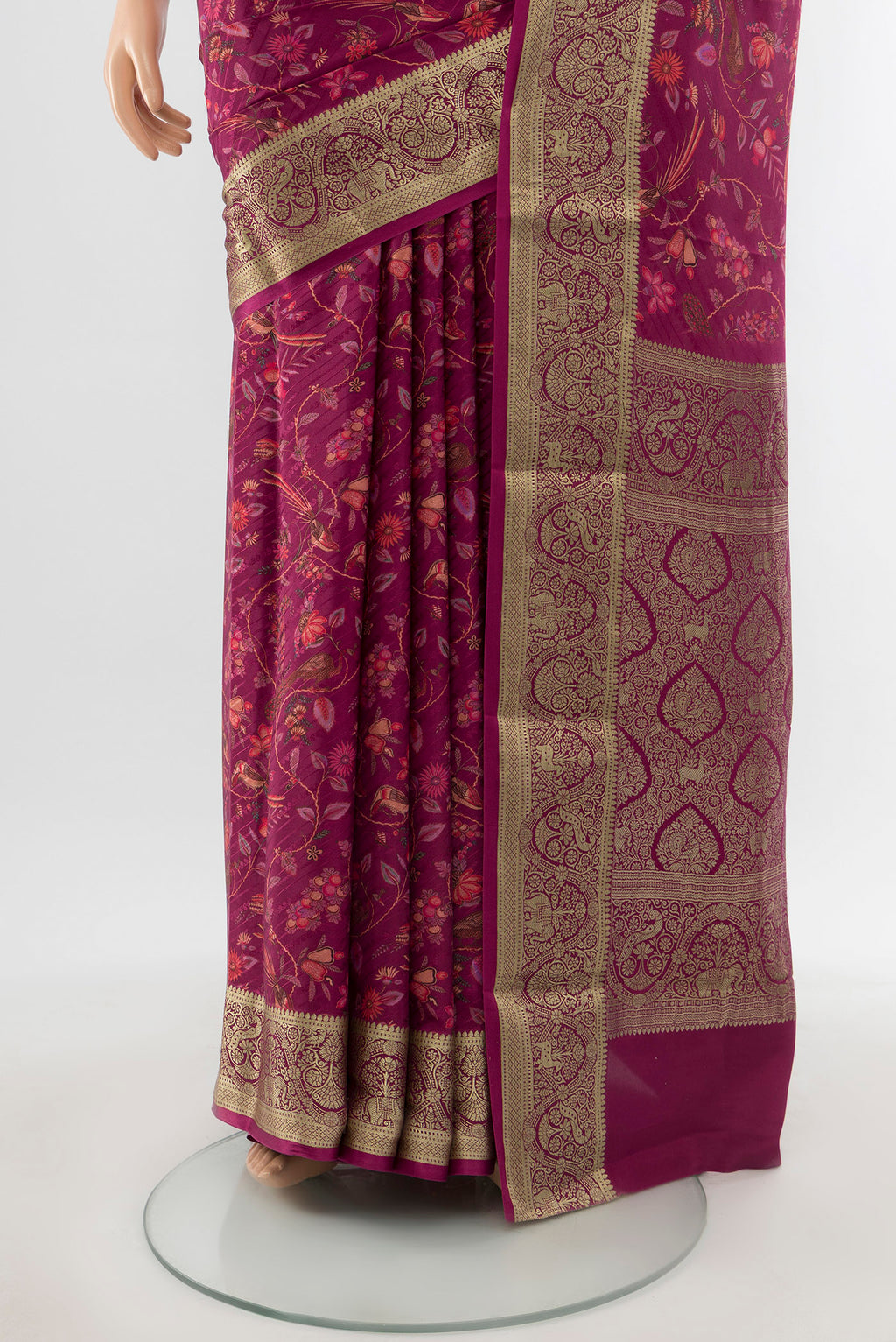 Pleats and pallu of Magenta Crepe Saree with Floral Print on the body and Zari Border. 