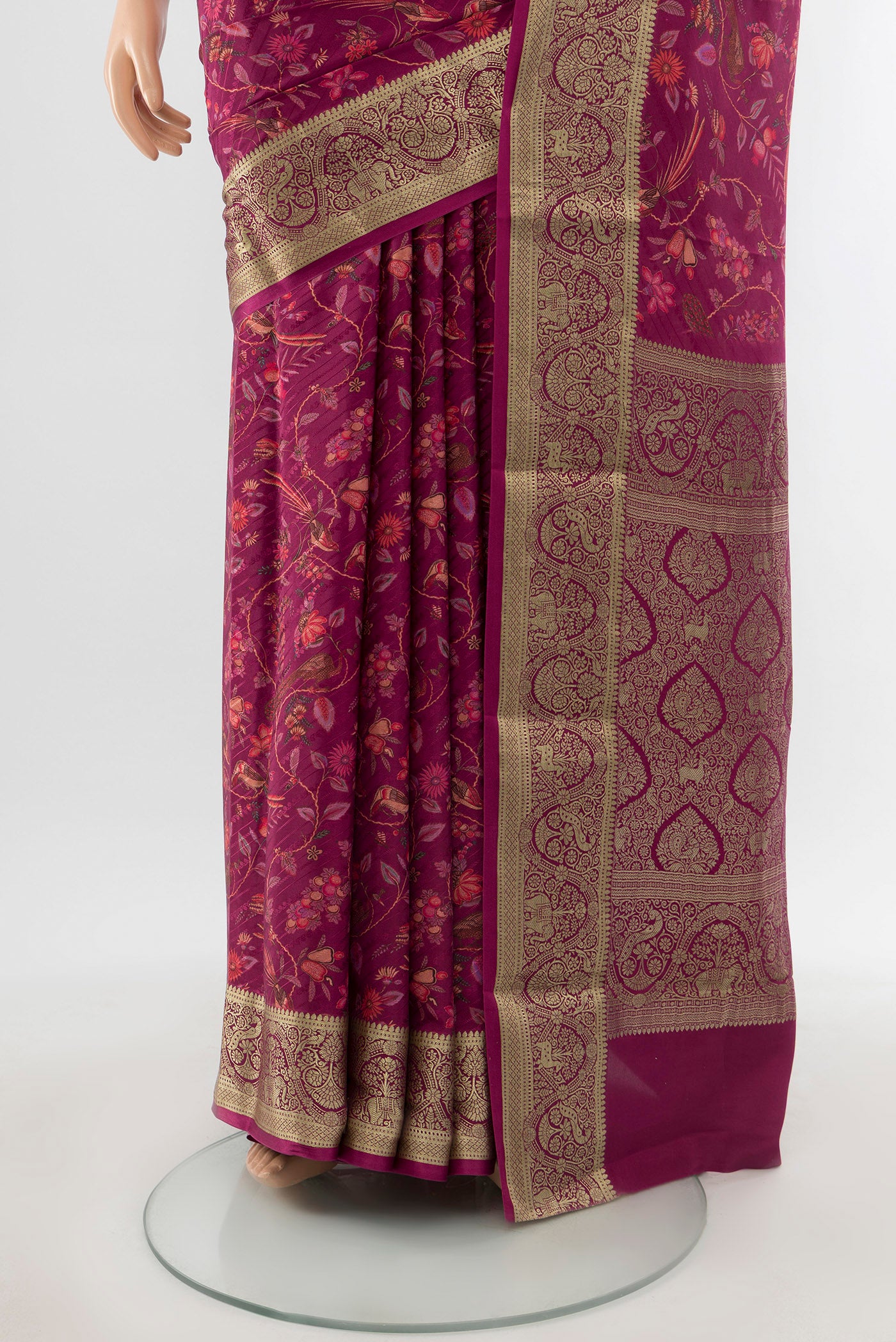 Pleats and pallu of Magenta Crepe Saree with Floral Print on the body and Zari Border. 