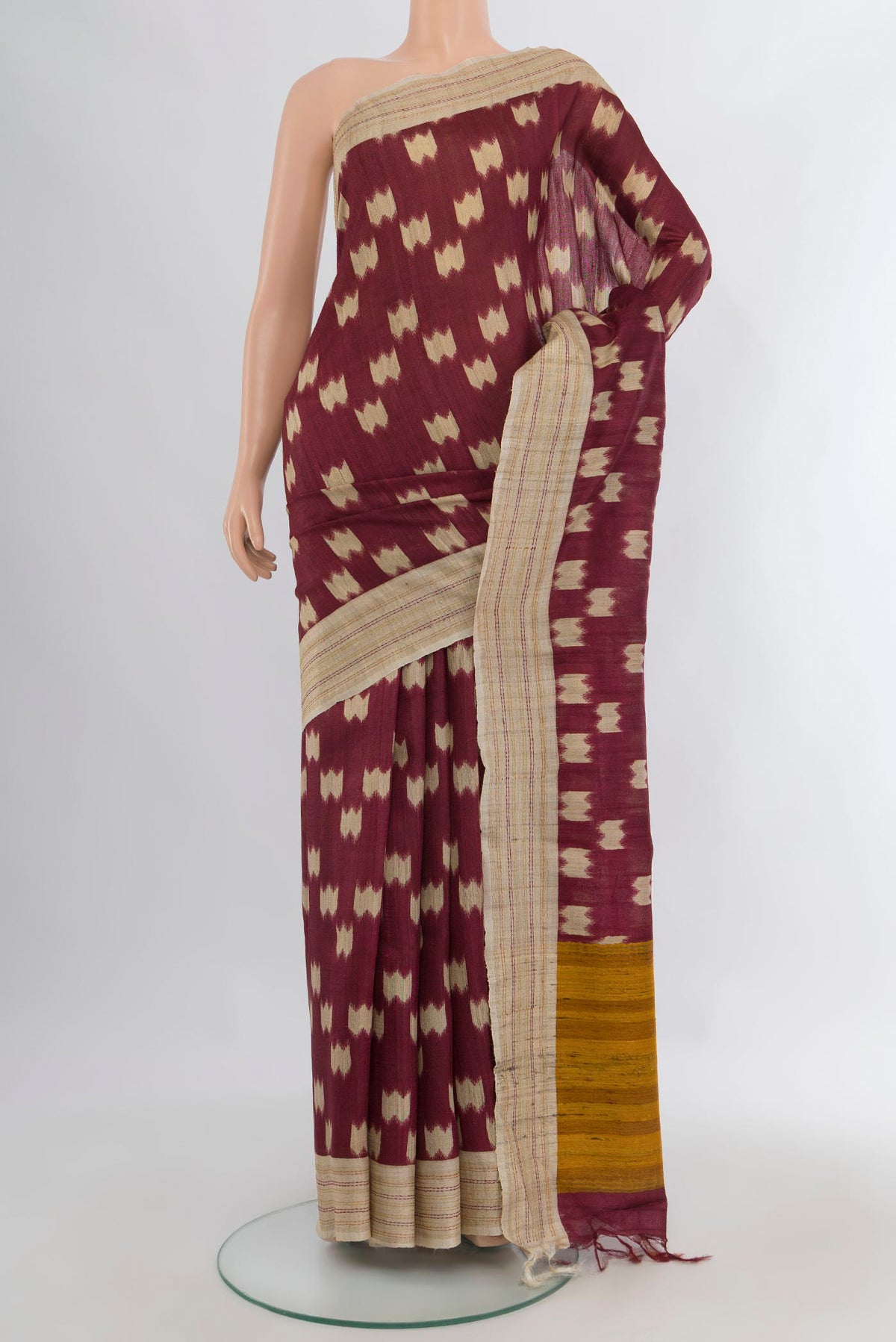 Brown Tussar Saree with Printed design on the body and Plain Border.  displayed on a mannequin
