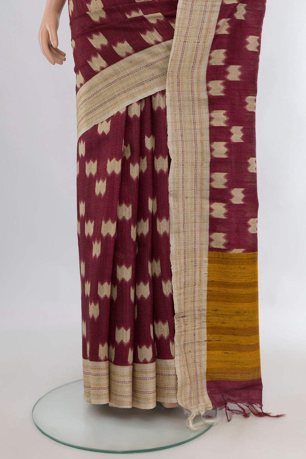 Pleats and pallu of Brown Tussar Saree with Printed design on the body and Plain Border. 