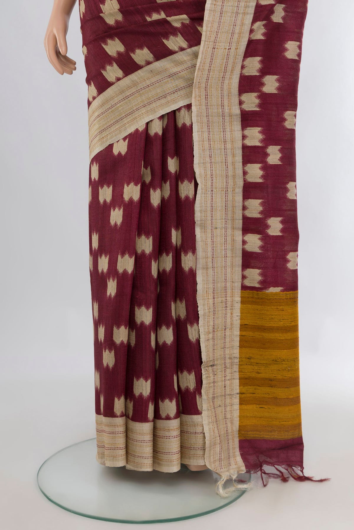 Pleats and pallu of Brown Tussar Saree with Printed design on the body and Plain Border. 