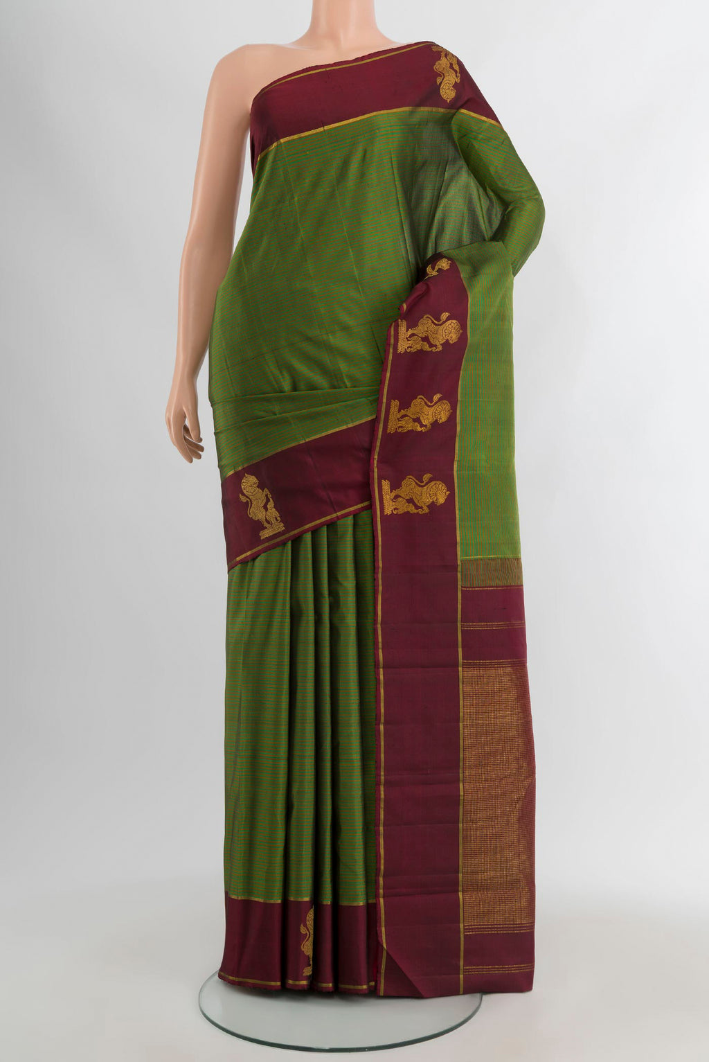Green Kanchipuram Silk Saree with Stripes on the body and Plain Border.  displayed on a mannequin
