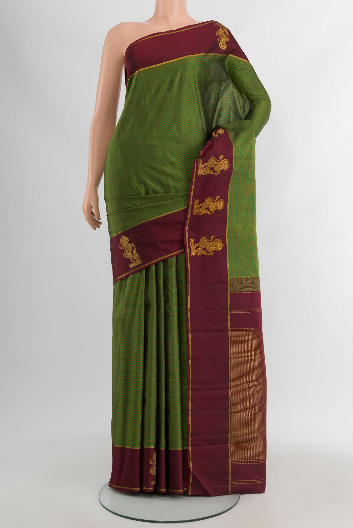Green Kanchipuram Silk Saree with Stripes on the body and Plain Border.  displayed on a mannequin