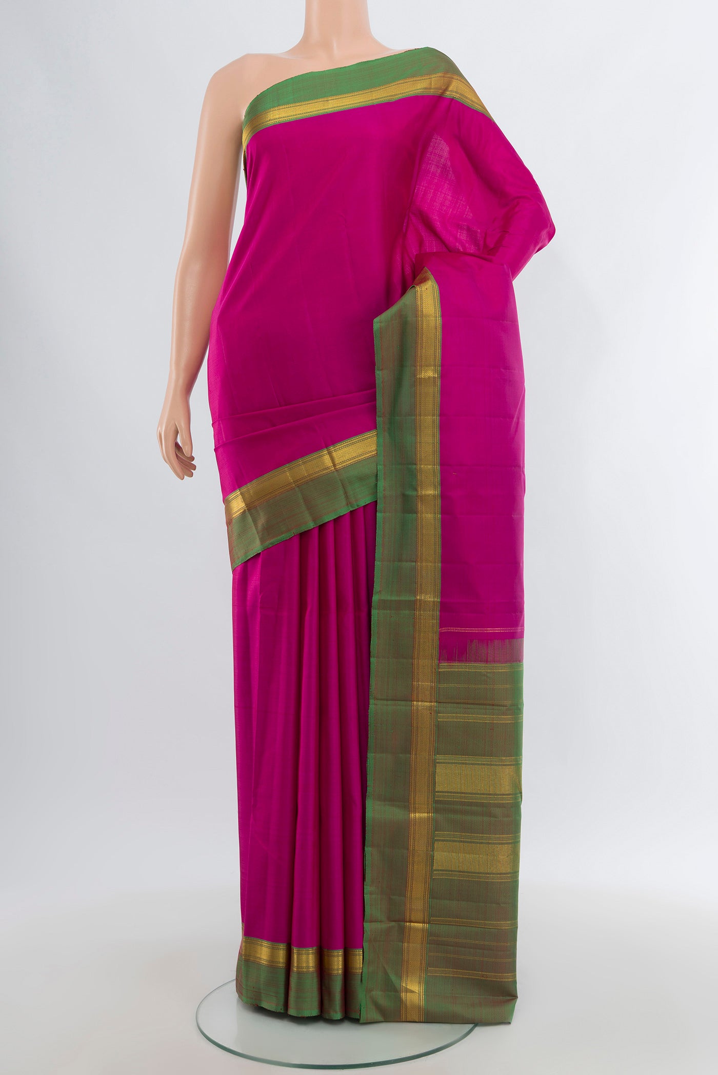 Rani Pink Kanjivaram Silk Saree with Plain Body and Zari Border.  displayed on a mannequin
