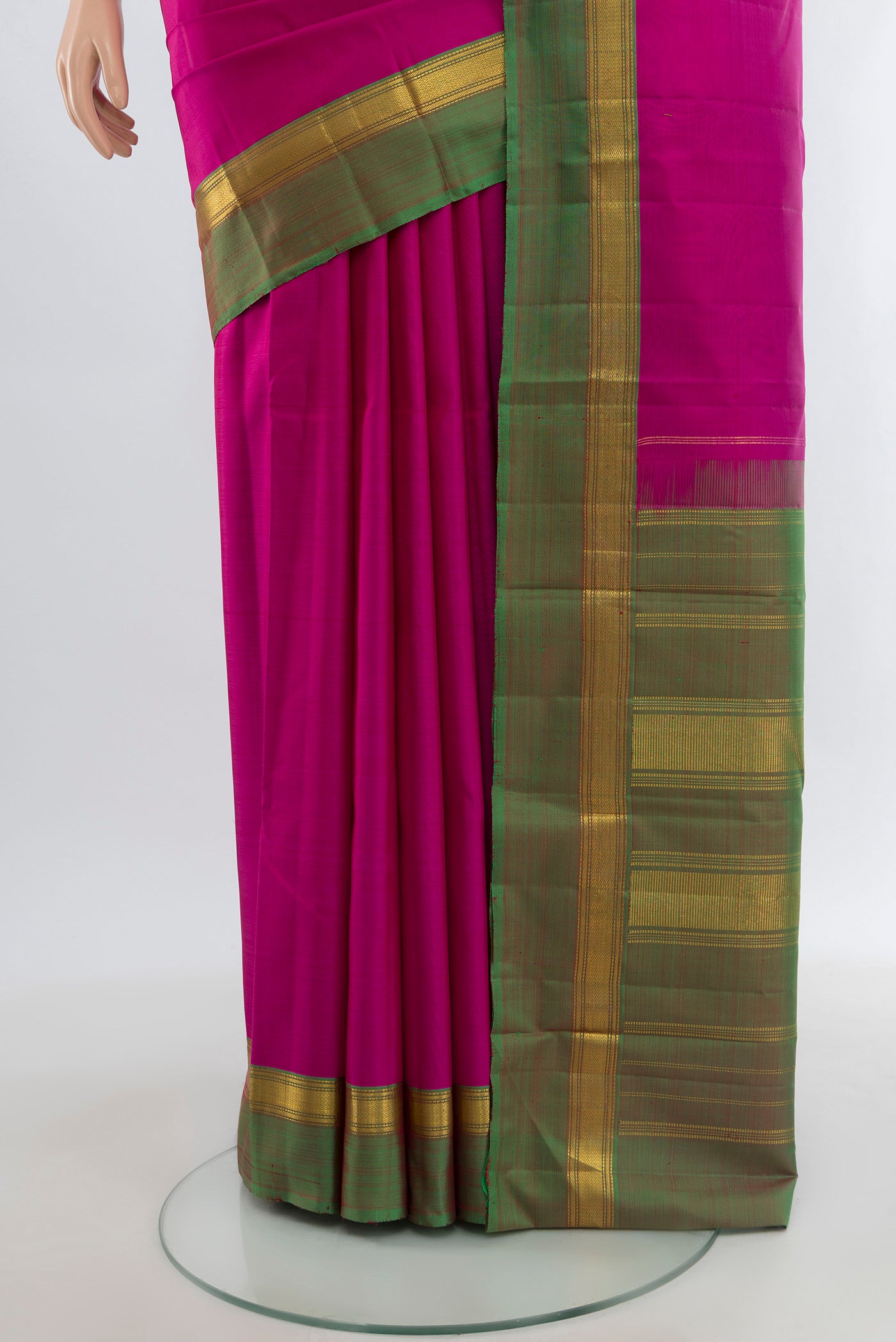 Pleats and pallu of Rani Pink Kanjivaram Silk Saree with Plain Body and Zari Border. 