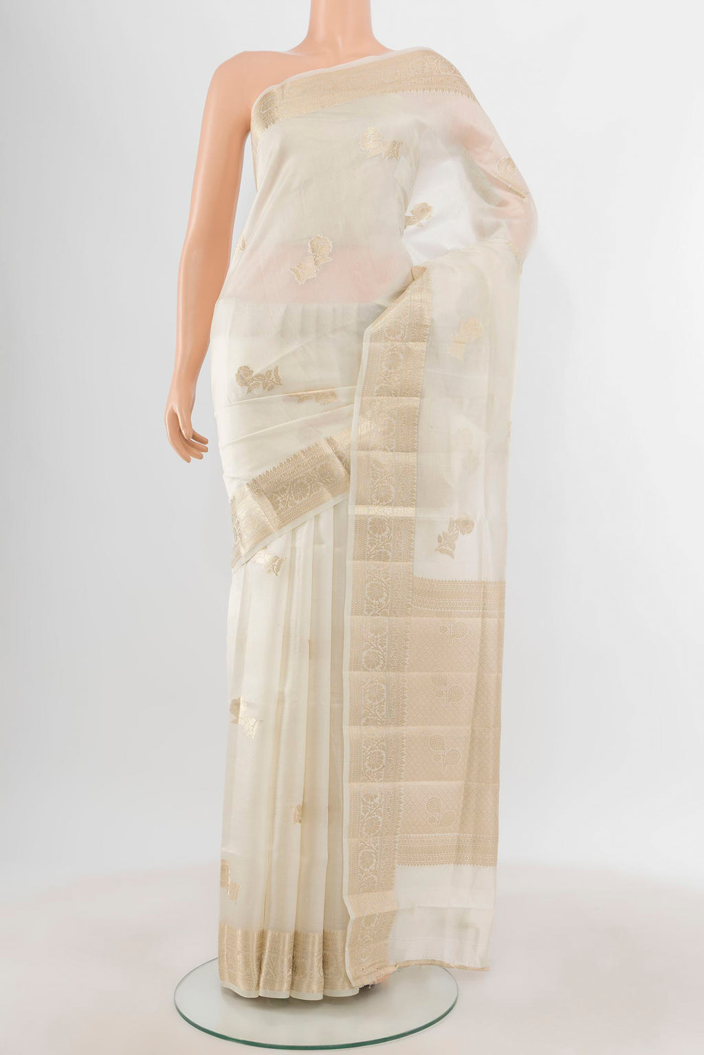 White Banarasi Raw Silk Saree with Zari Butta on the body and Zari Border.  displayed on a mannequin