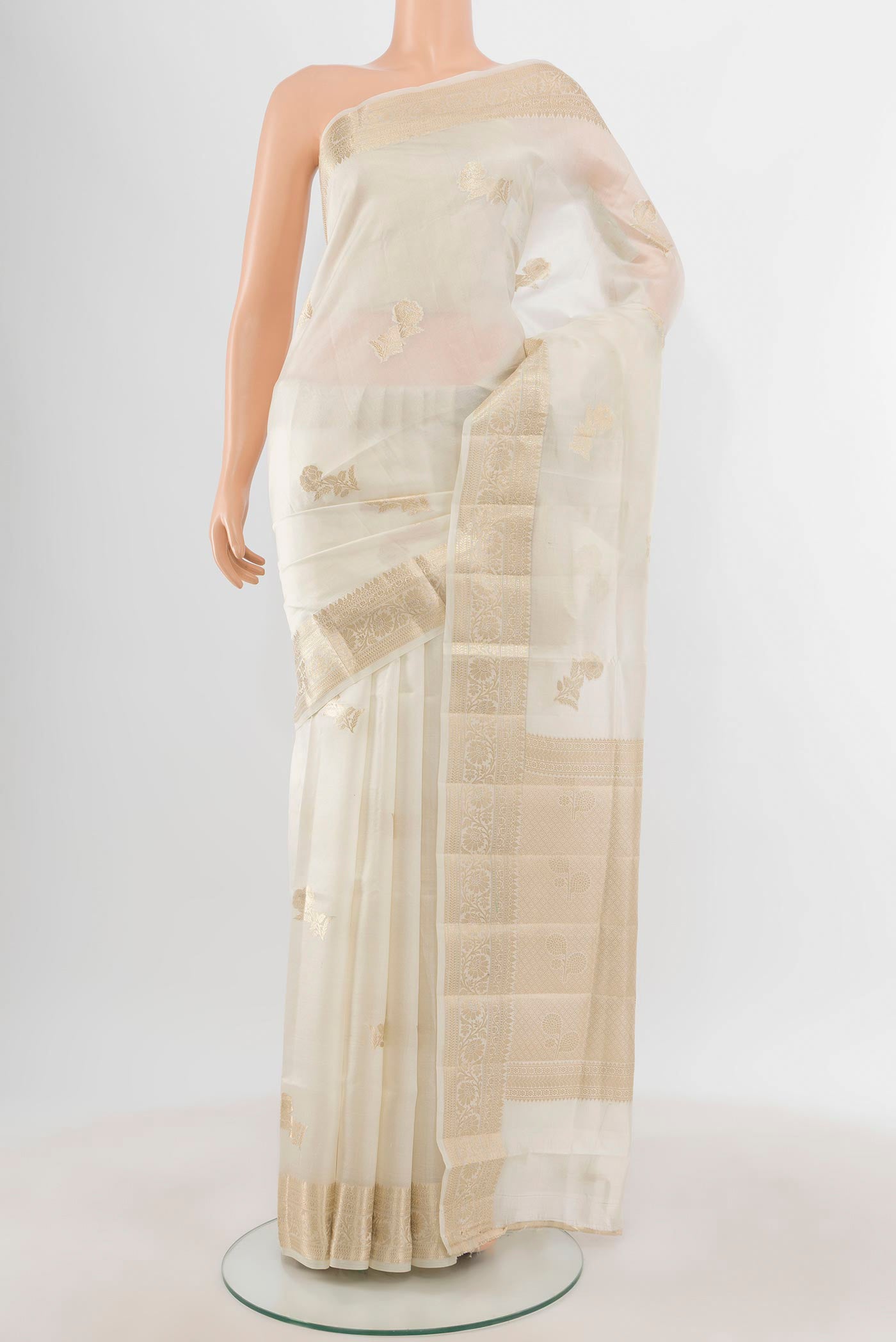 White Banarasi Raw Silk Saree with Zari Butta on the body and Zari Border.  displayed on a mannequin