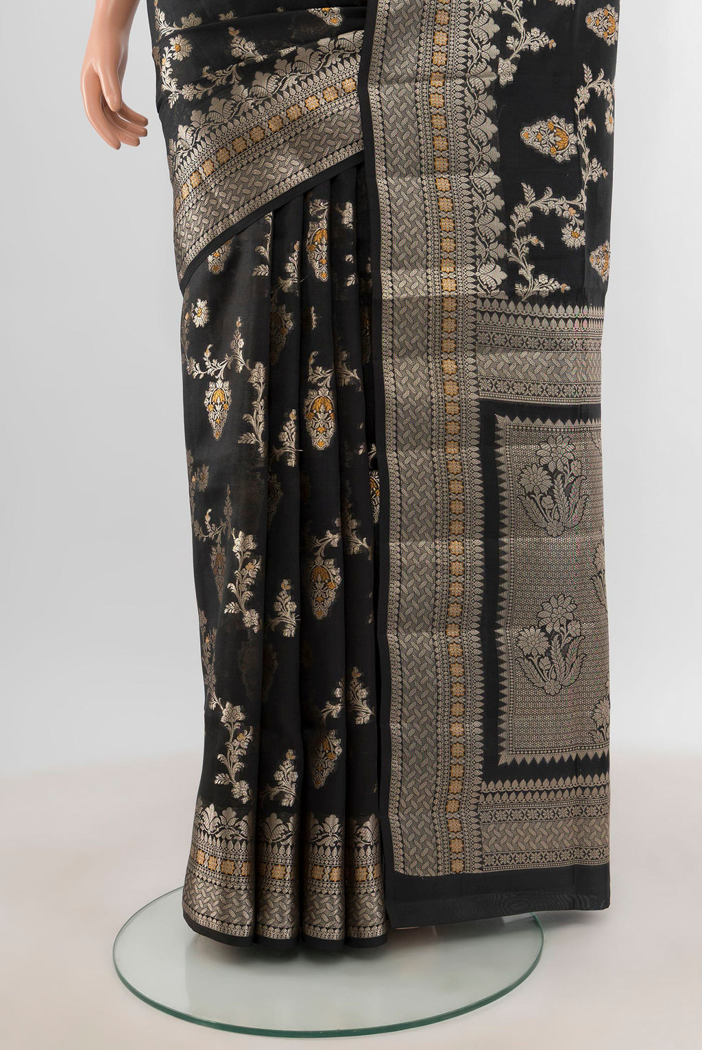 Pleats and pallu of Black Banarasi Raw Silk Saree with Zari And Thread Butta on the body and Zari Border. 