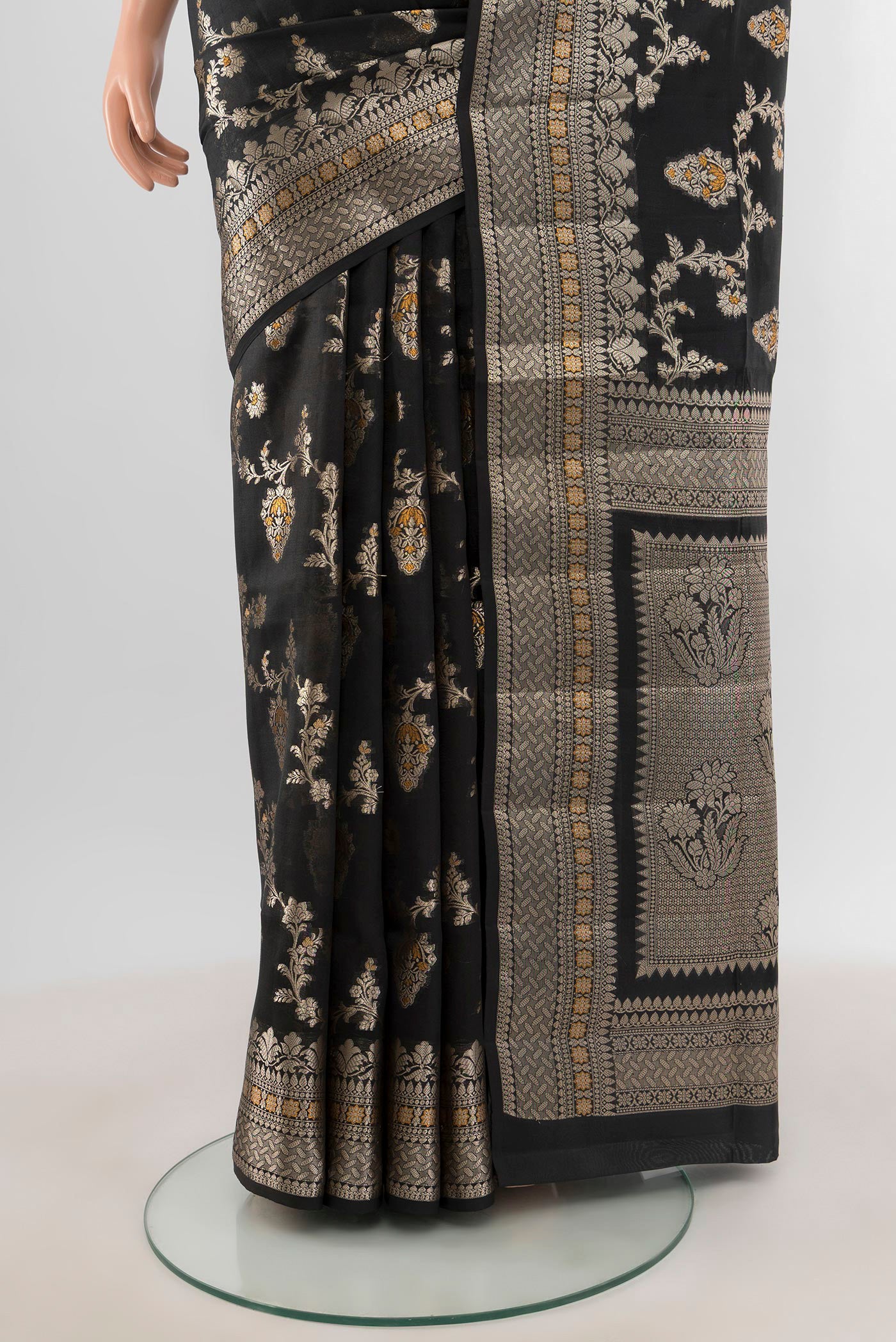 Pleats and pallu of Black Banarasi Raw Silk Saree with Zari And Thread Butta on the body and Zari Border. 