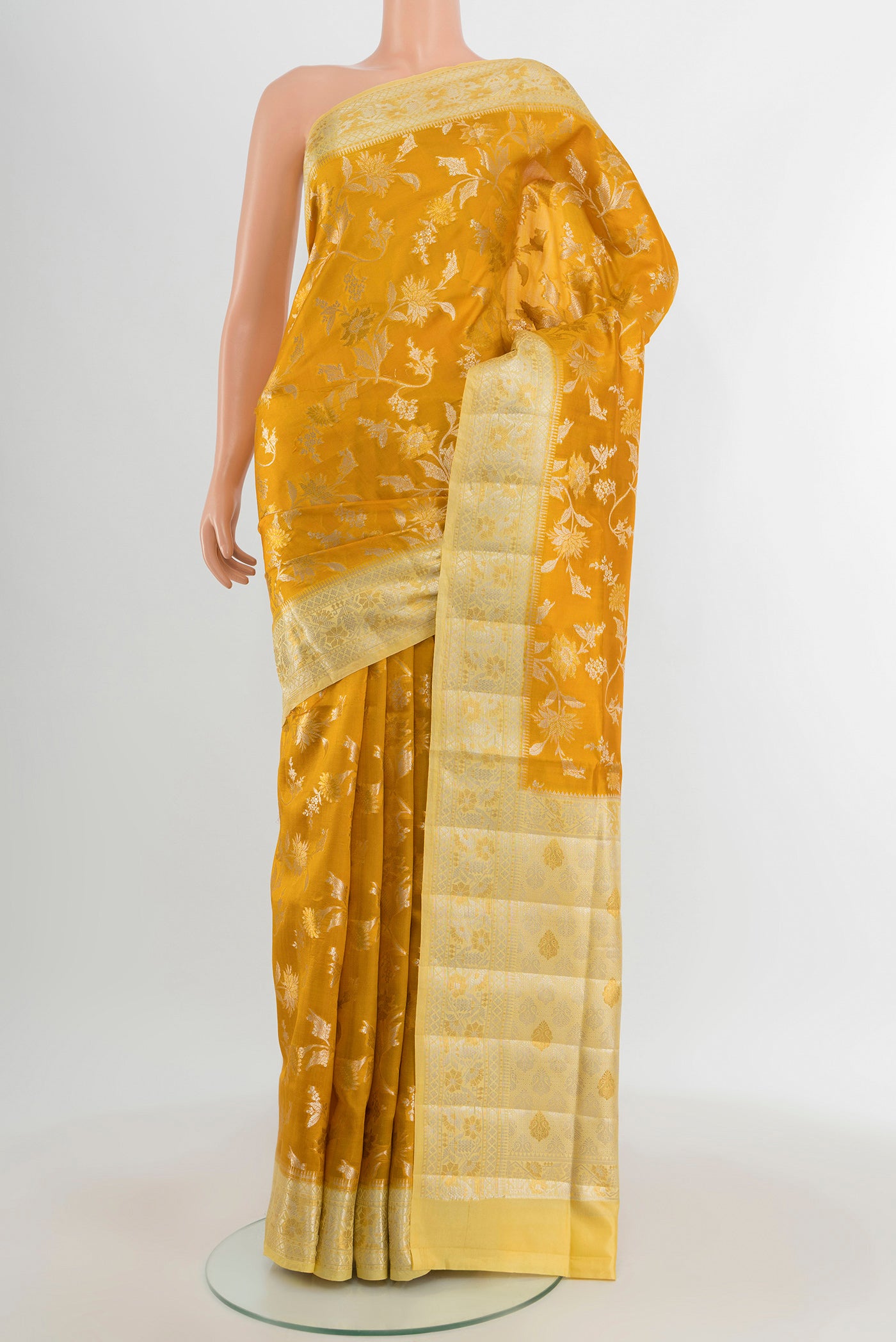 Yellow Banarasi Raw Silk Saree with Zari Butta on the body and Zari Border.  displayed on a mannequin