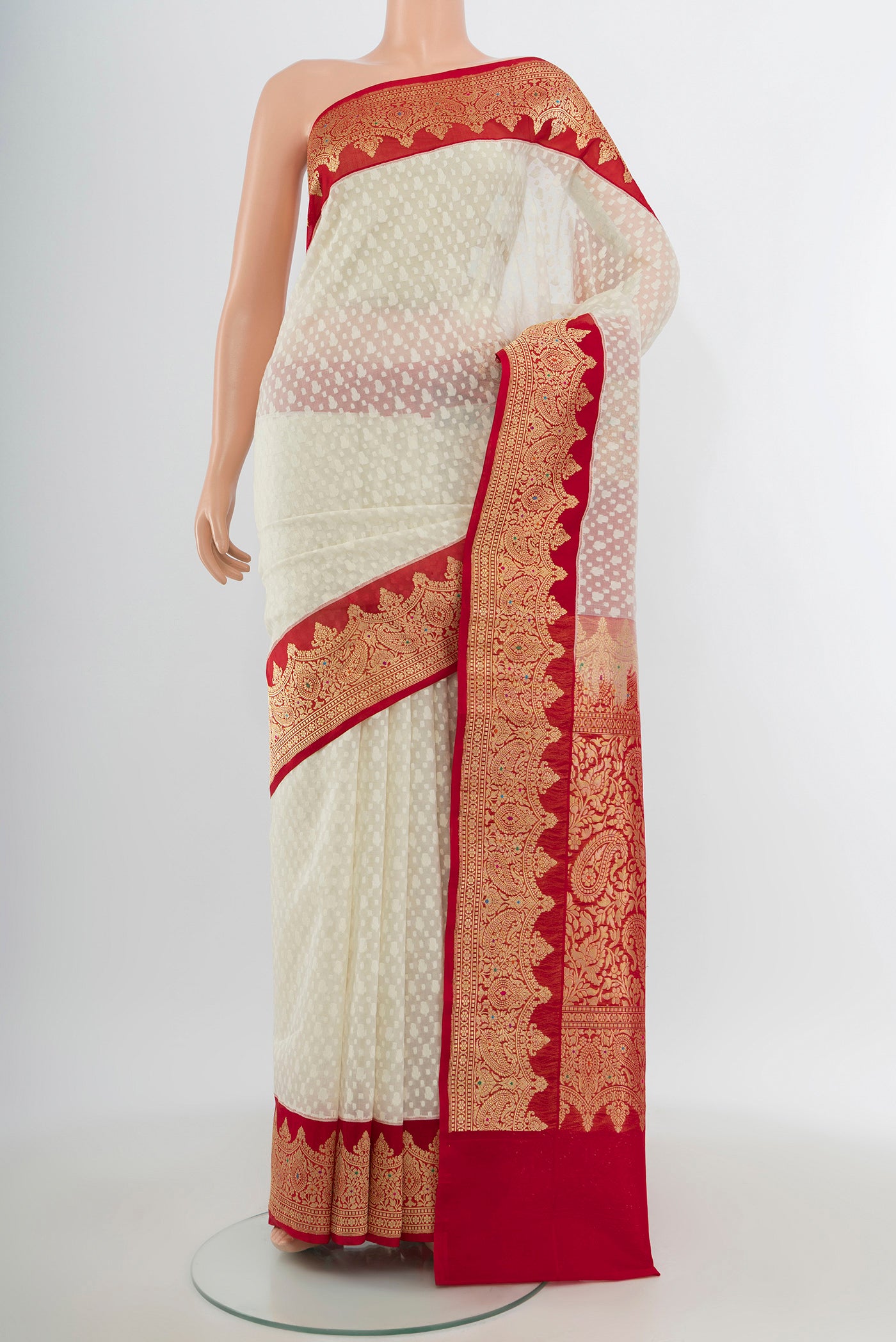 Off White Banarasi Kora Silk Saree with Jacquard design on the body and Zari Border.  displayed on a mannequin