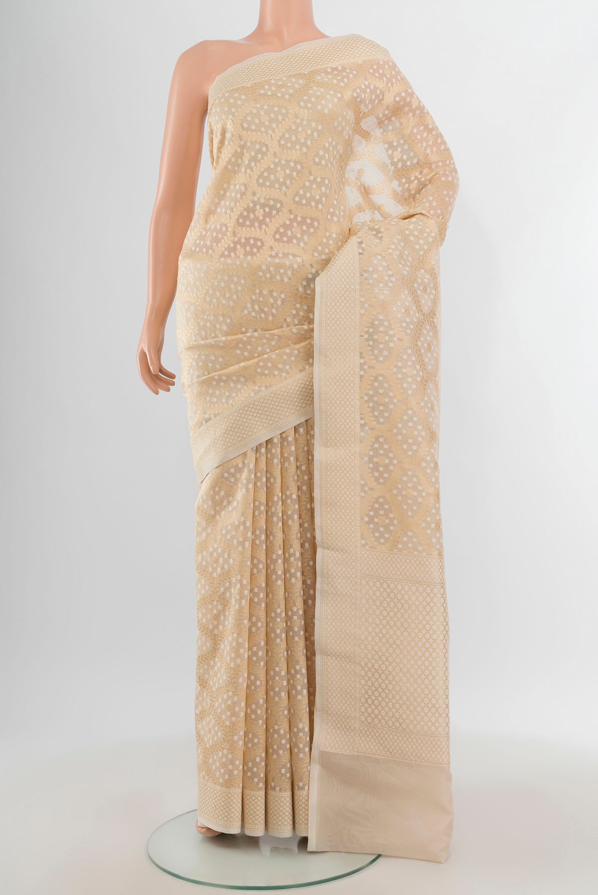 Cream Banarasi Kora Silk Saree with Zari And Thread Butta on the body and Zari Border.  displayed on a mannequin