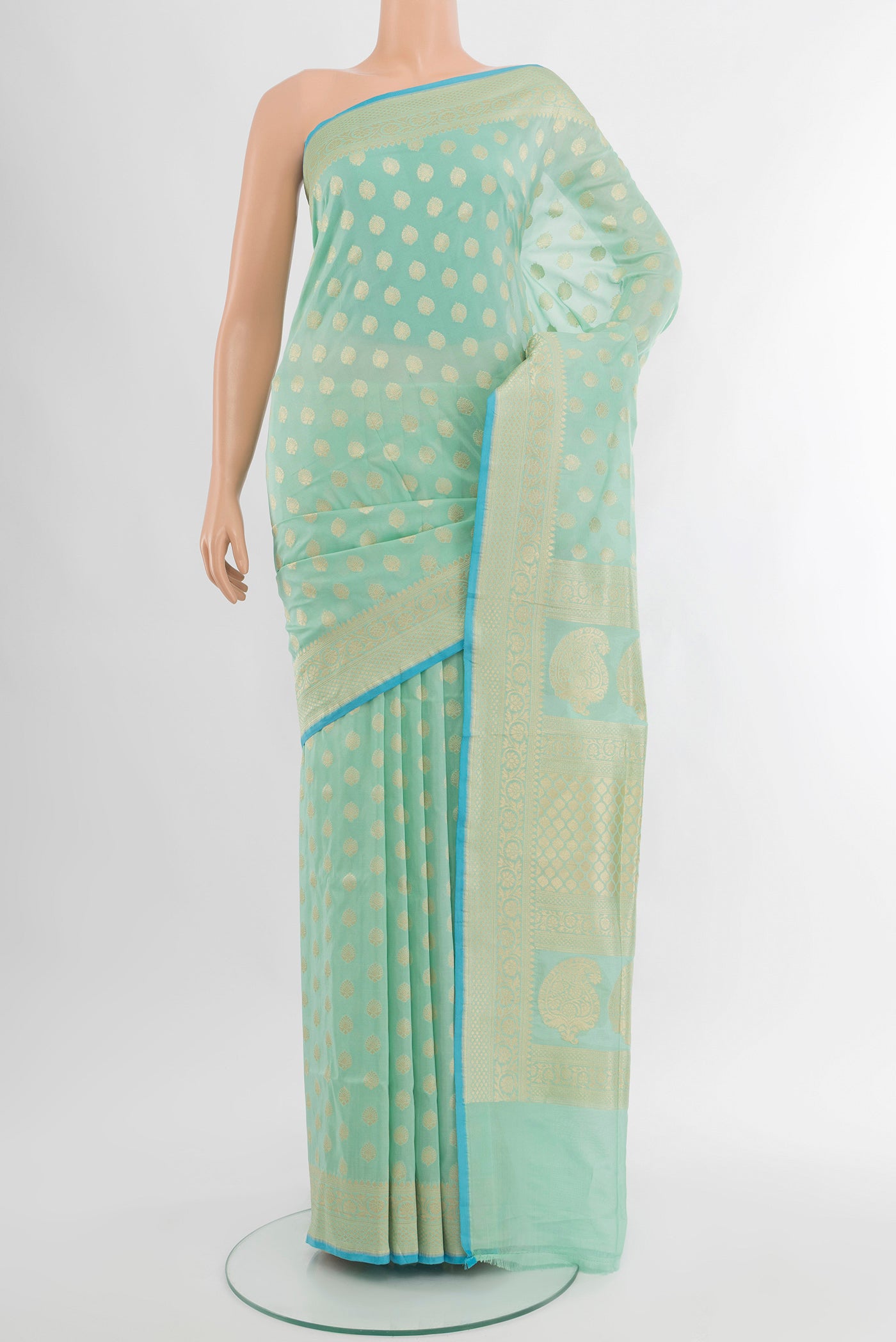 Pure Silk Pure Zari Light Green Banarasi Saree with Zari Butta on the body and Silk Border.  displayed on a mannequin