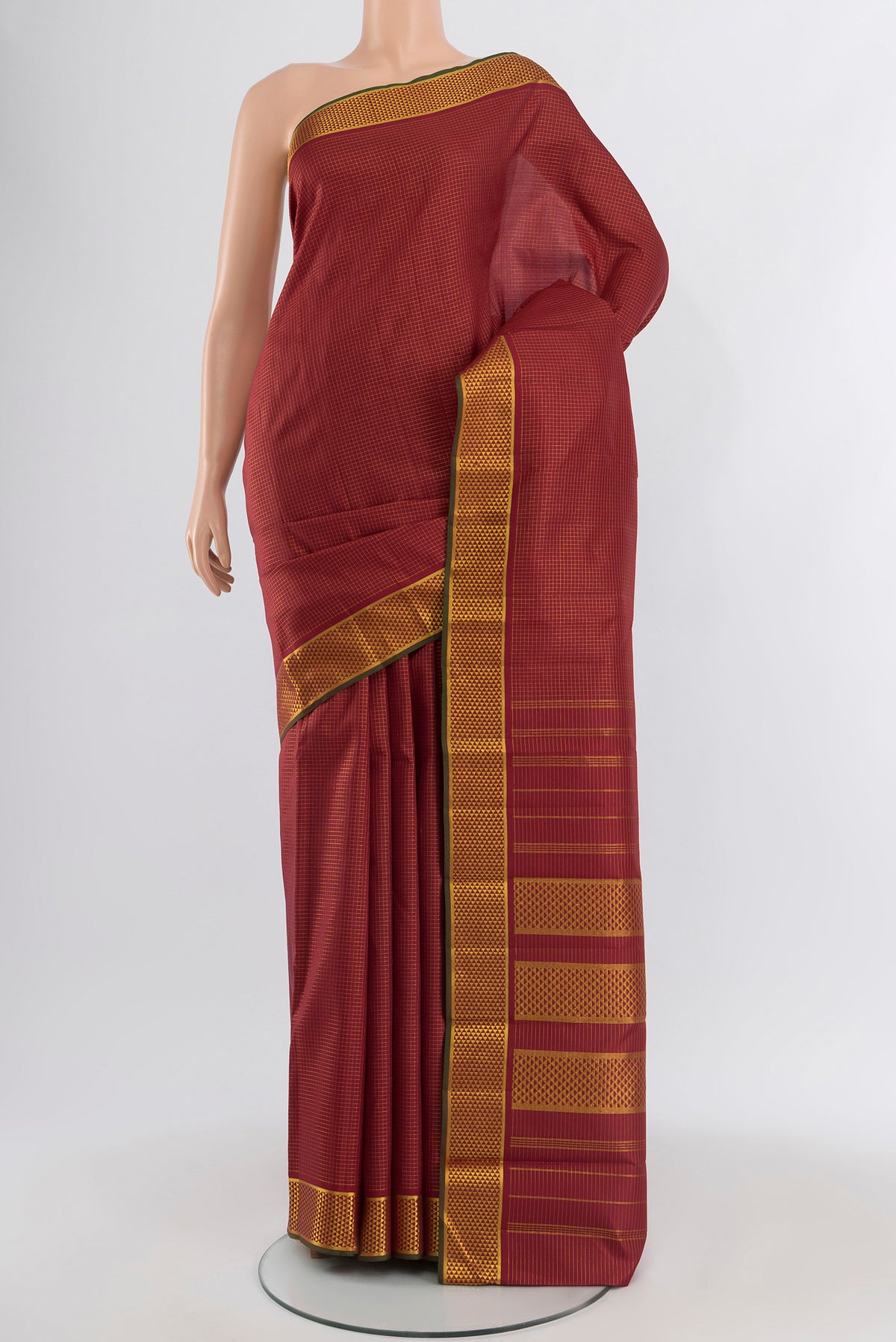 Maroon Kanchipuram Silk Saree with Checked design on the body and Zari Border.  displayed on a mannequin