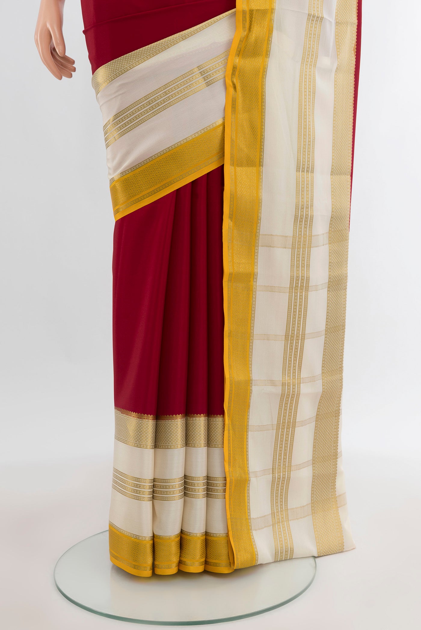 Pleats and pallu of Maroon Mysore Crepe Saree with Plain Body and Zari Border. 
