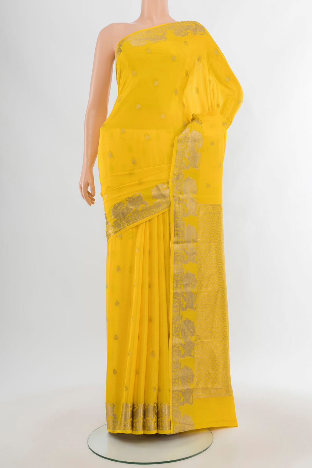 Yellow Mysore Crepe Saree with Zari Butta on the body and Zari Border.  displayed on a mannequin