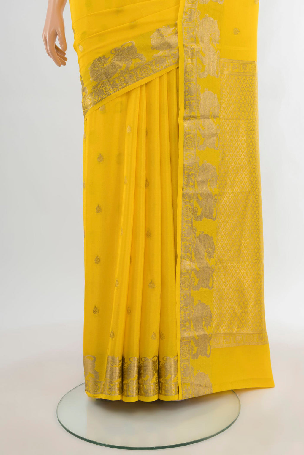 Pleats and pallu of Yellow Mysore Crepe Saree with Zari Butta on the body and Zari Border. 