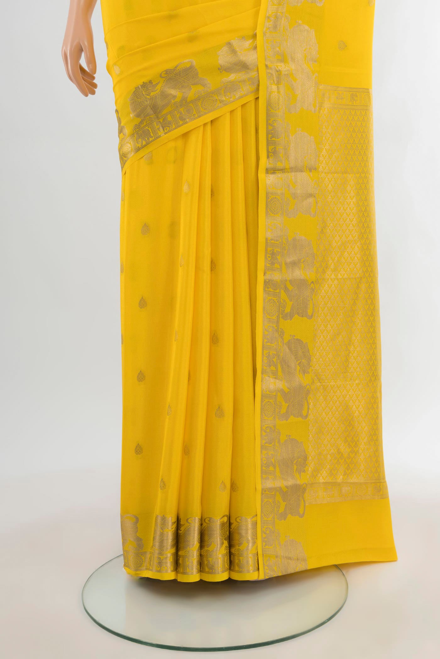 Pleats and pallu of Yellow Mysore Crepe Saree with Zari Butta on the body and Zari Border. 