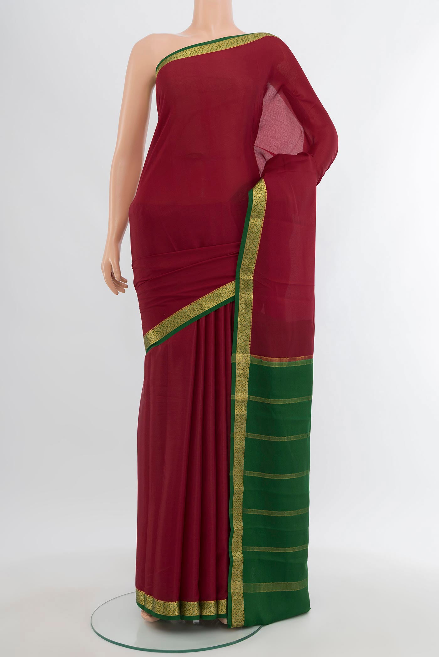 Maroon Mysore Crepe Saree with Plain Body and Zari Border.  displayed on a mannequin