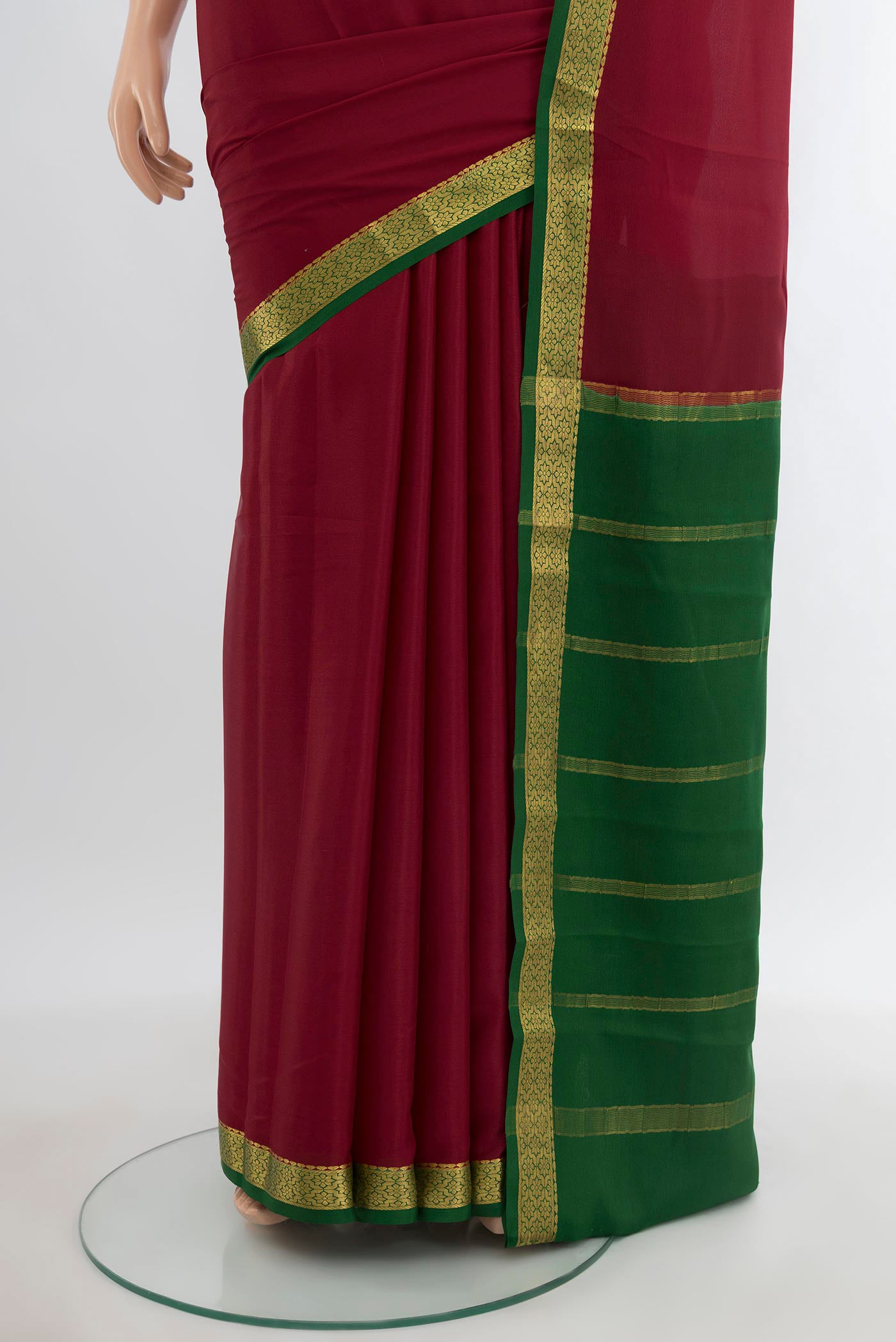 Pleats and pallu of Maroon Mysore Crepe Saree with Plain Body and Zari Border. 