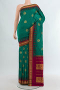 Teal Bangalore Silk - kadyal Saree with Zari Butta on the body and Temple Border.  displayed on a mannequin