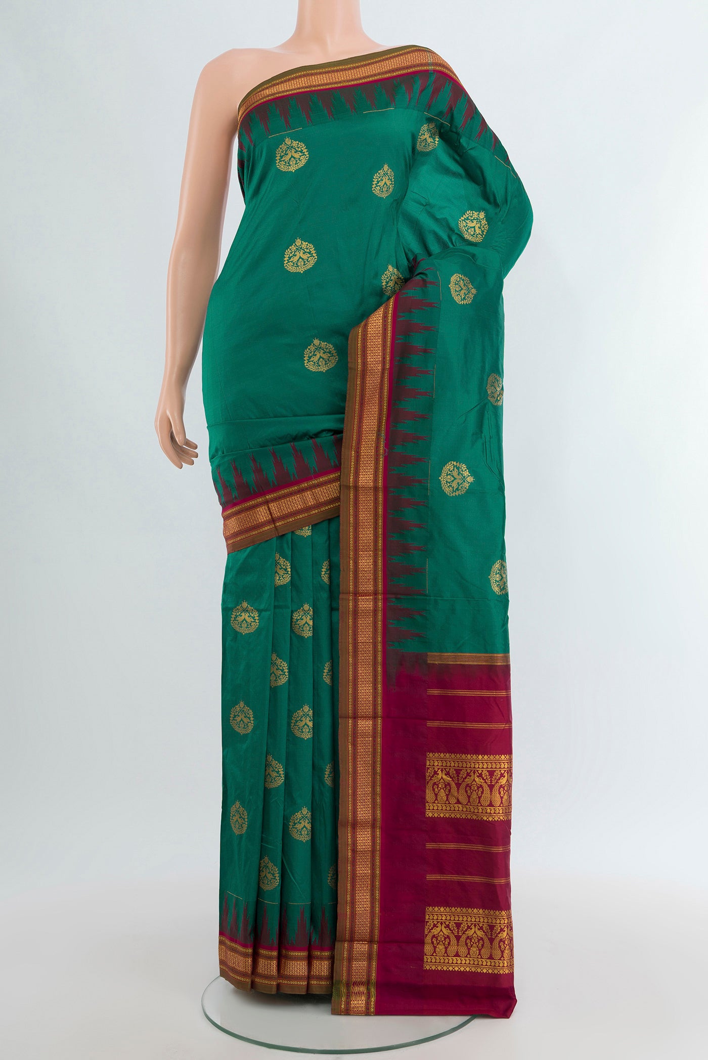 Teal Bangalore Silk - kadyal Saree with Zari Butta on the body and Temple Border.  displayed on a mannequin