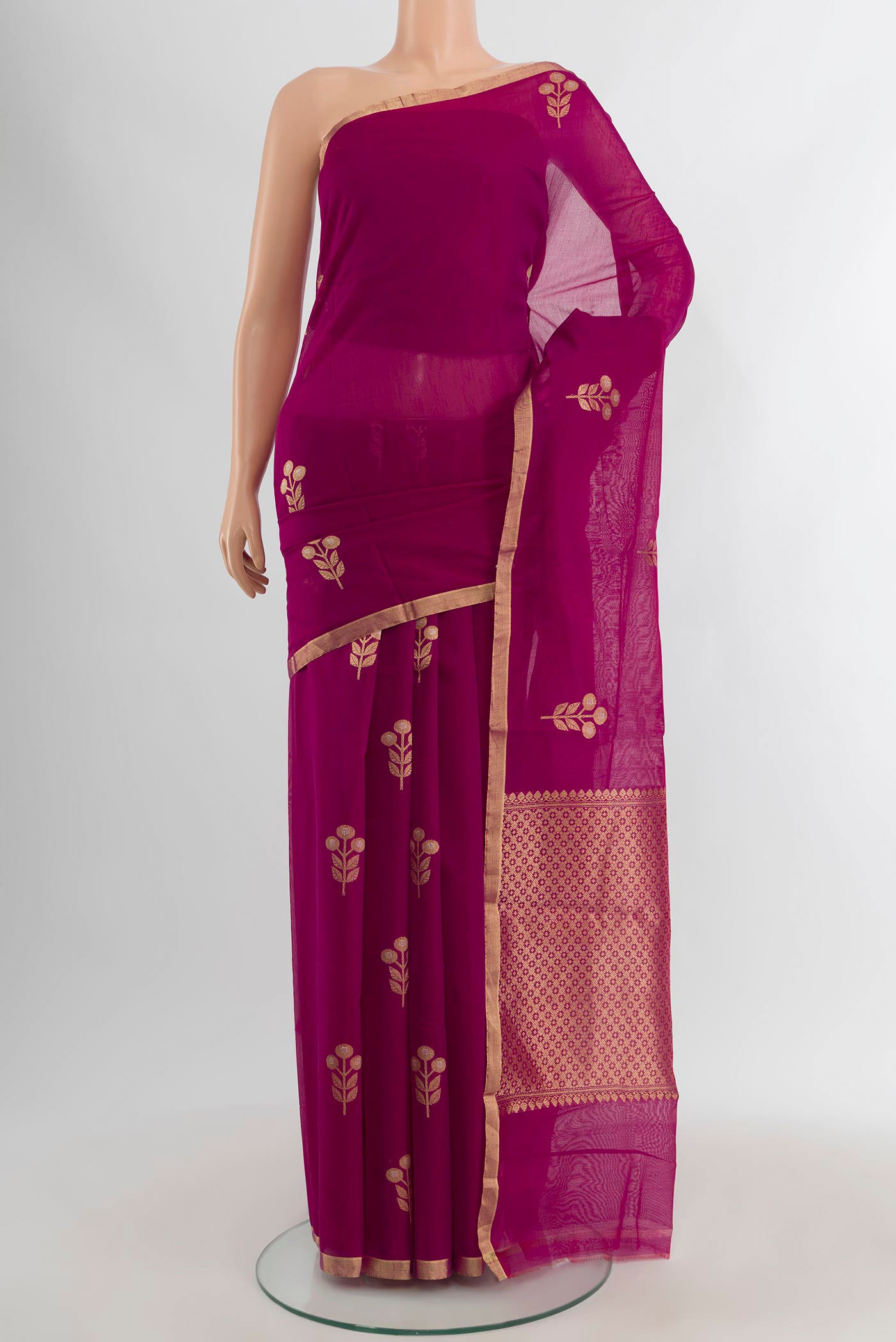 Magenta Banarasi Kora Cotton Saree with Zari Butta on the body and Zari Border.  displayed on a mannequin