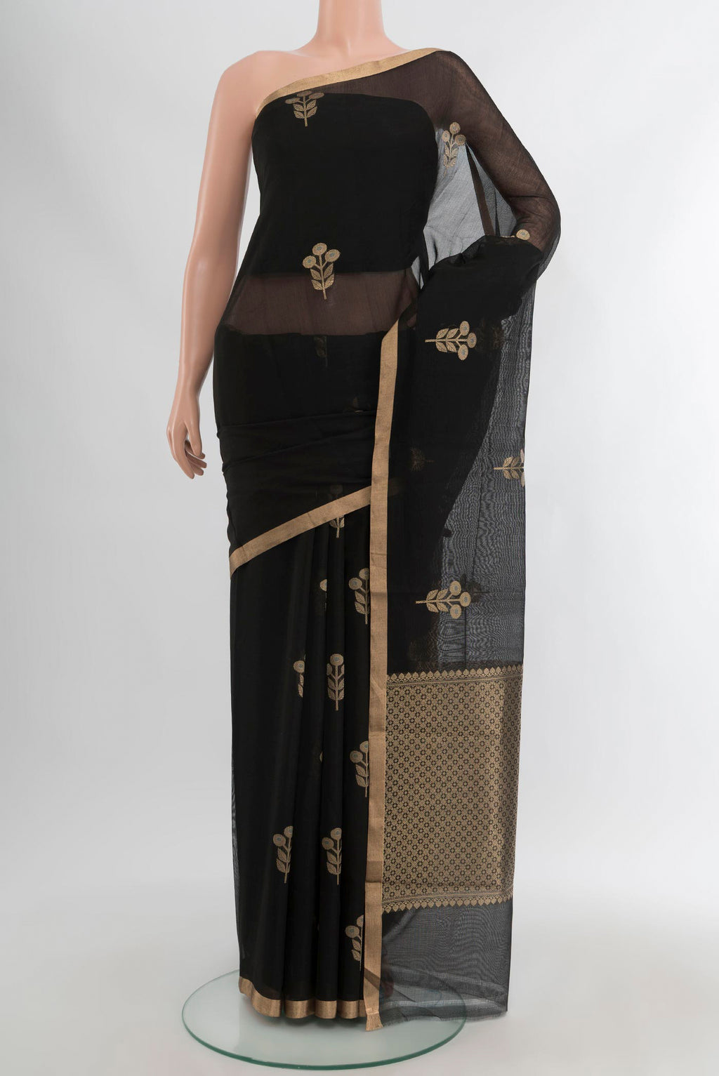 Black Banarasi Kora Cotton Saree with Zari Butta on the body and Zari Border.  displayed on a mannequin