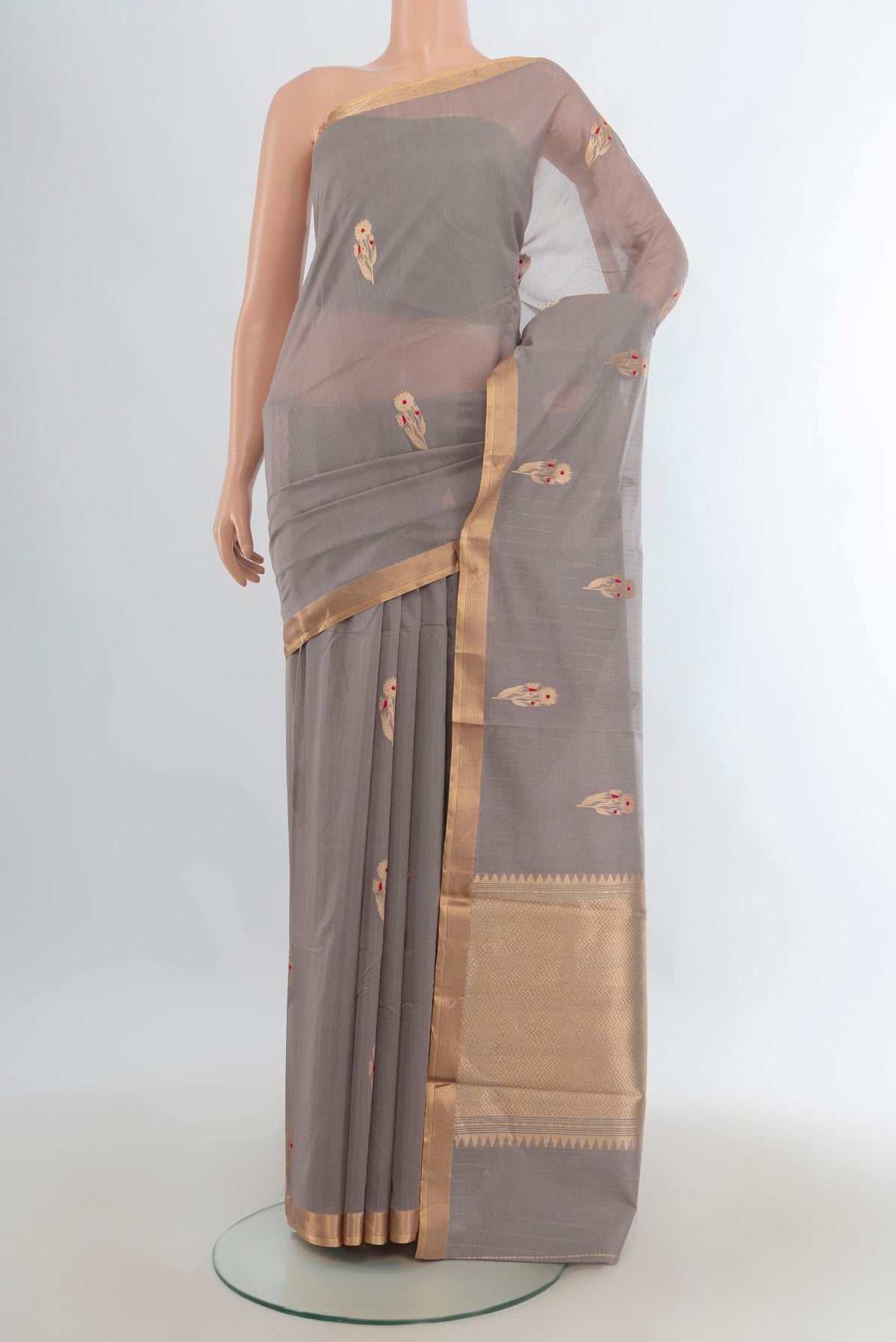 Grey Banarasi Kora Cotton Saree with Zari Butta on the body and Zari Border.  displayed on a mannequin