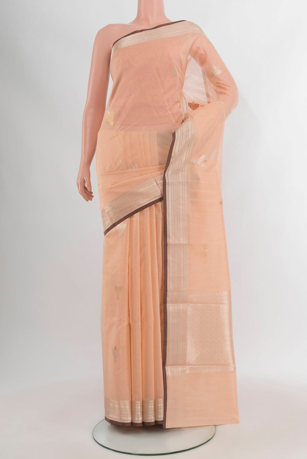 Peach Banarasi Kora Cotton Saree with Zari Butta on the body and Zari Border.  displayed on a mannequin
