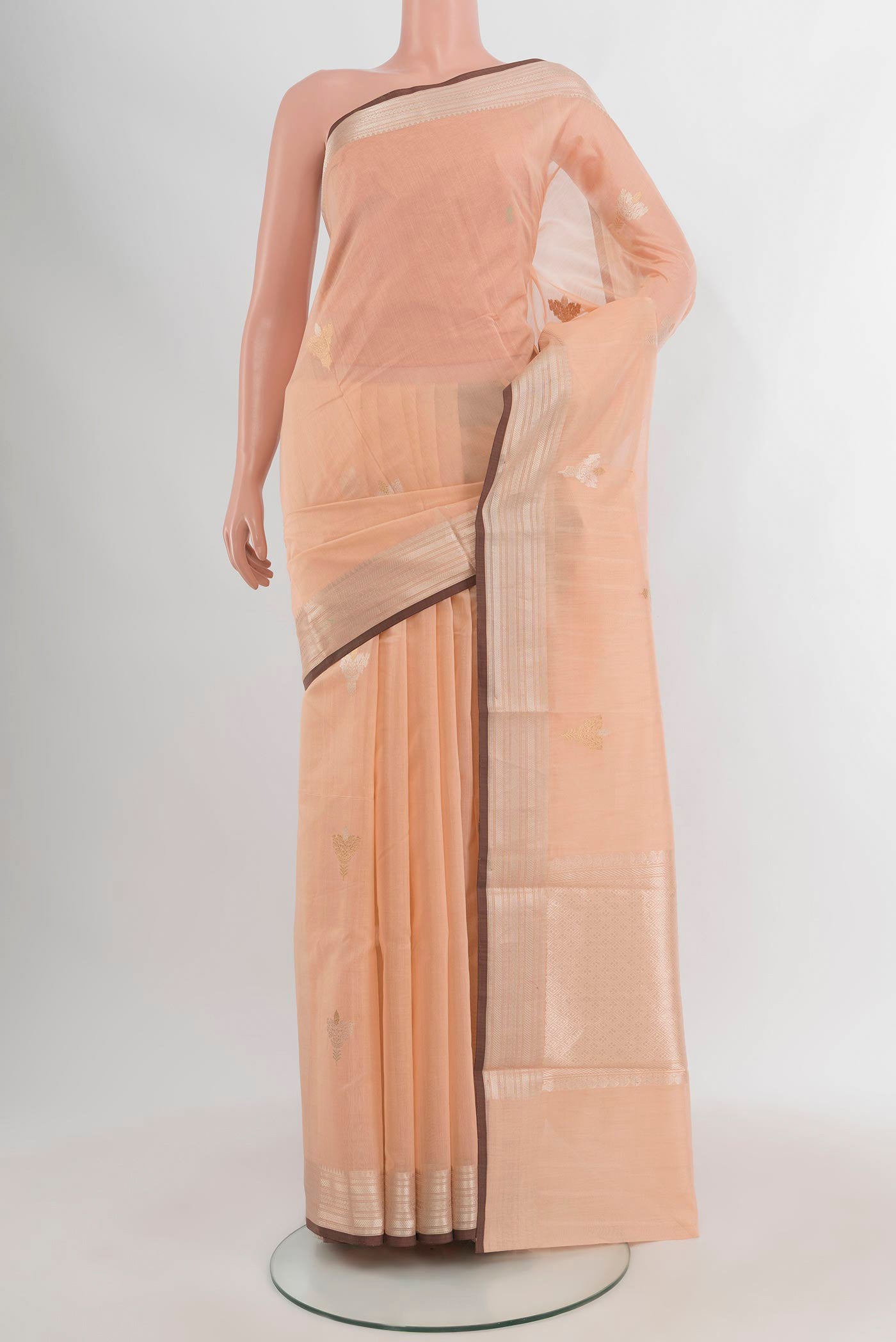 Peach Banarasi Kora Cotton Saree with Zari Butta on the body and Zari Border.  displayed on a mannequin