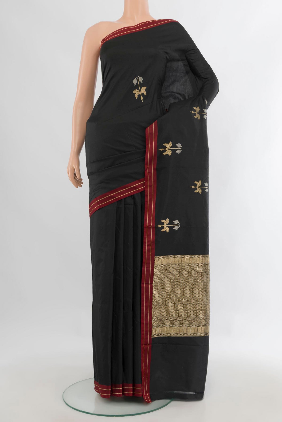 Pure Silk Black Banarasi Katan Saree with Zari Butta on the body and Plain Border.  displayed on a mannequin