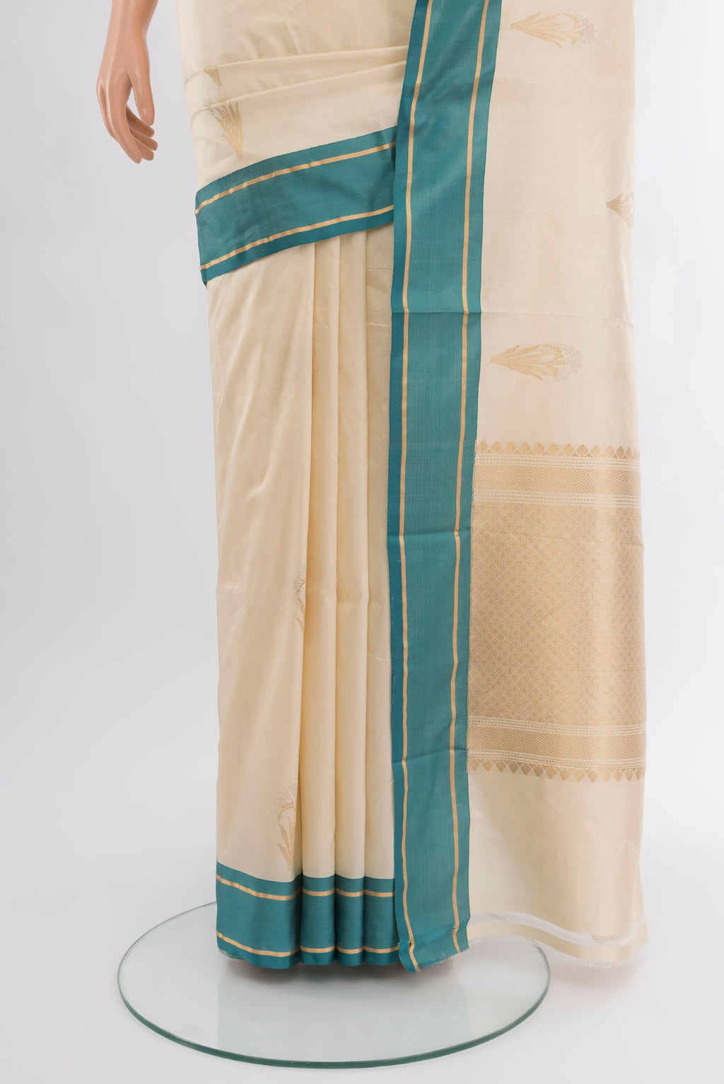 Pleats and pallu of Cream Banarasi Katan Silk Saree with Zari Butta on the body and Plain Border. 
