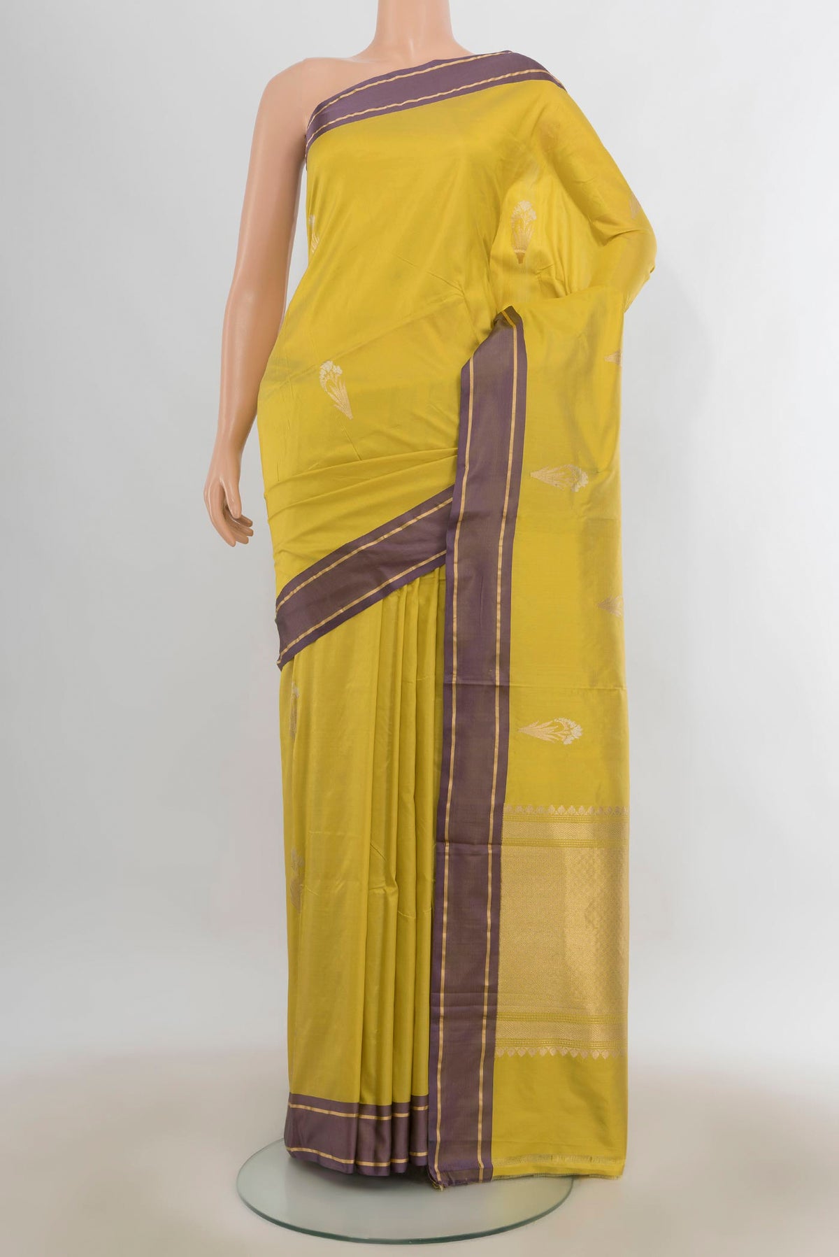 Pure Silk Mehandi Green Banarasi Katan Saree with Zari Butta on the body and Zari Border.  displayed on a mannequin
