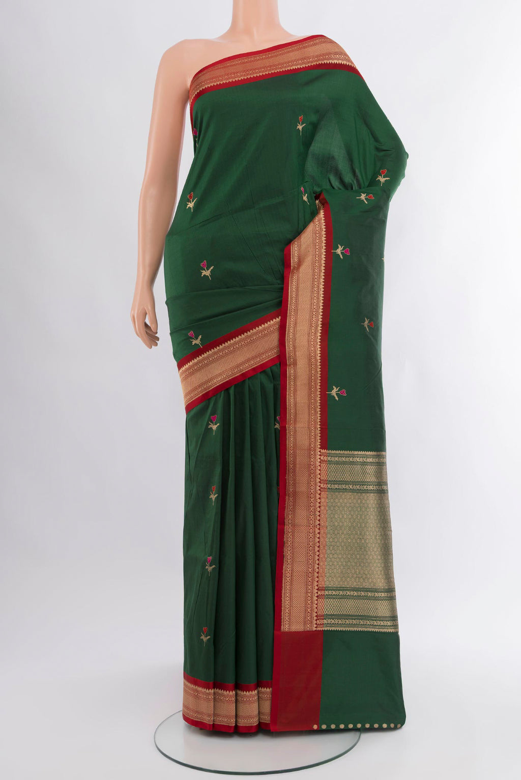 Bottle Green Banarasi Katan Silk Saree with Zari Butta on the body and Zari Border.  displayed on a mannequin