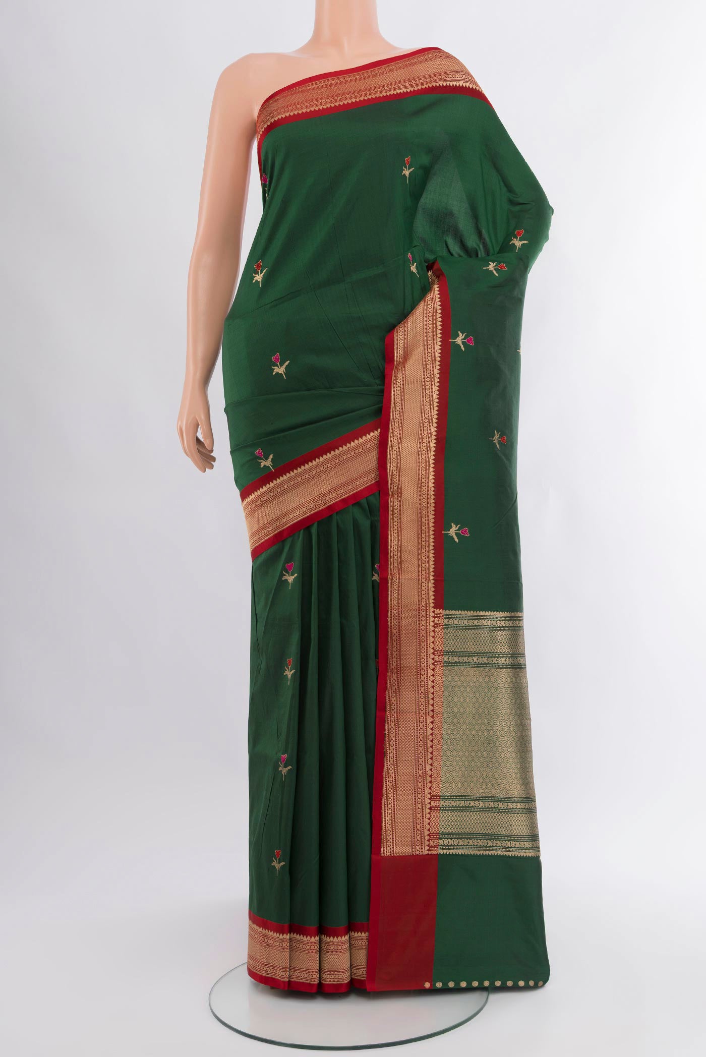 Bottle Green Banarasi Katan Silk Saree with Zari Butta on the body and Zari Border.  displayed on a mannequin