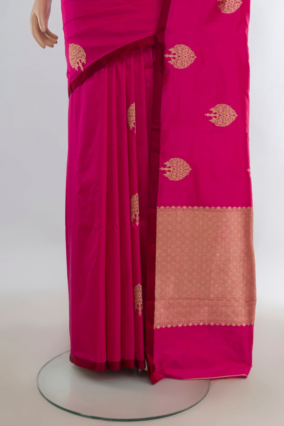 Pleats and pallu of Pure Silk Rani Pink Banarasi Katan Saree with Zari Butta on the body and Without Border. 
