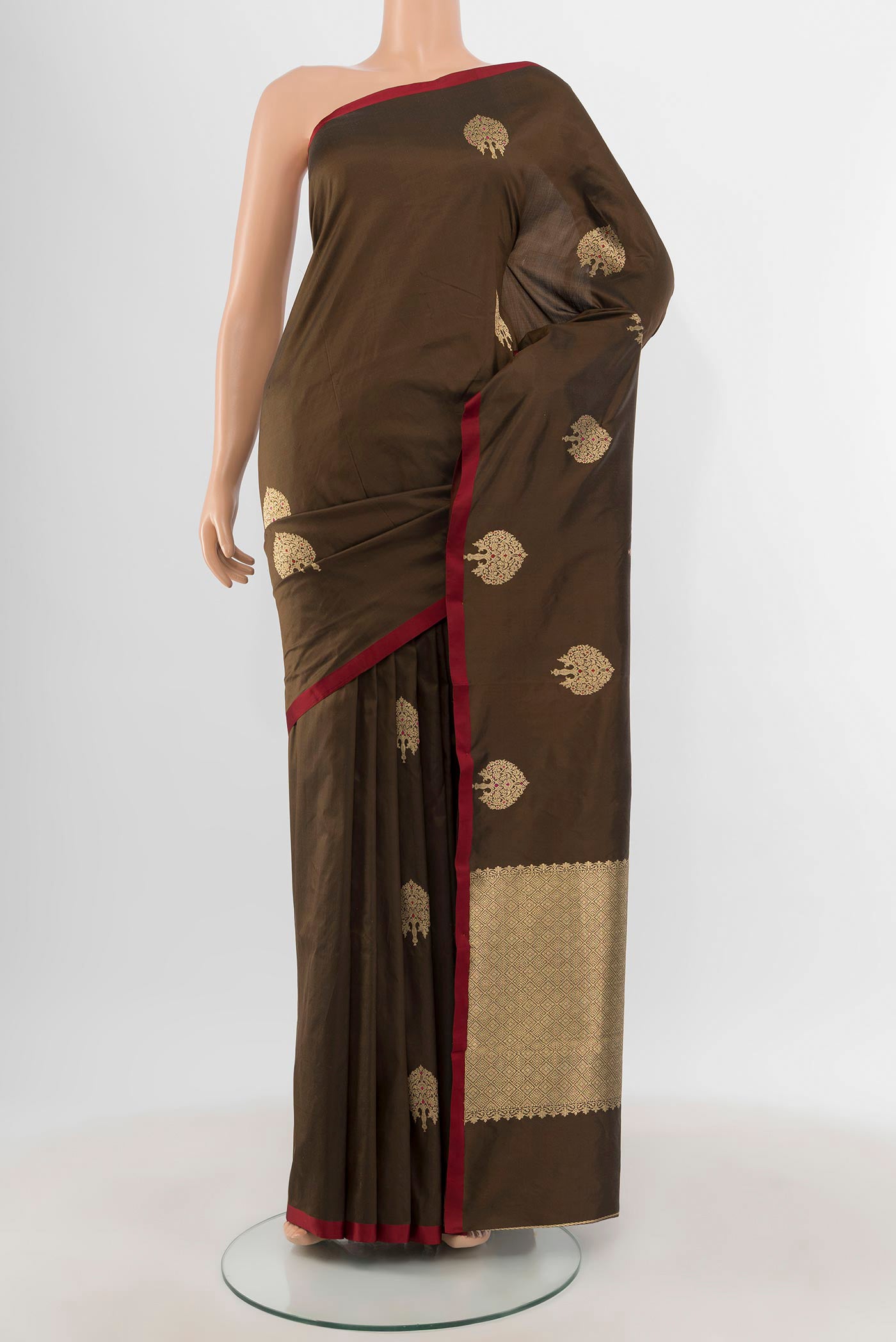Brown Banarasi Katan Silk Saree with Zari Butta on the body and Plain Border.  displayed on a mannequin