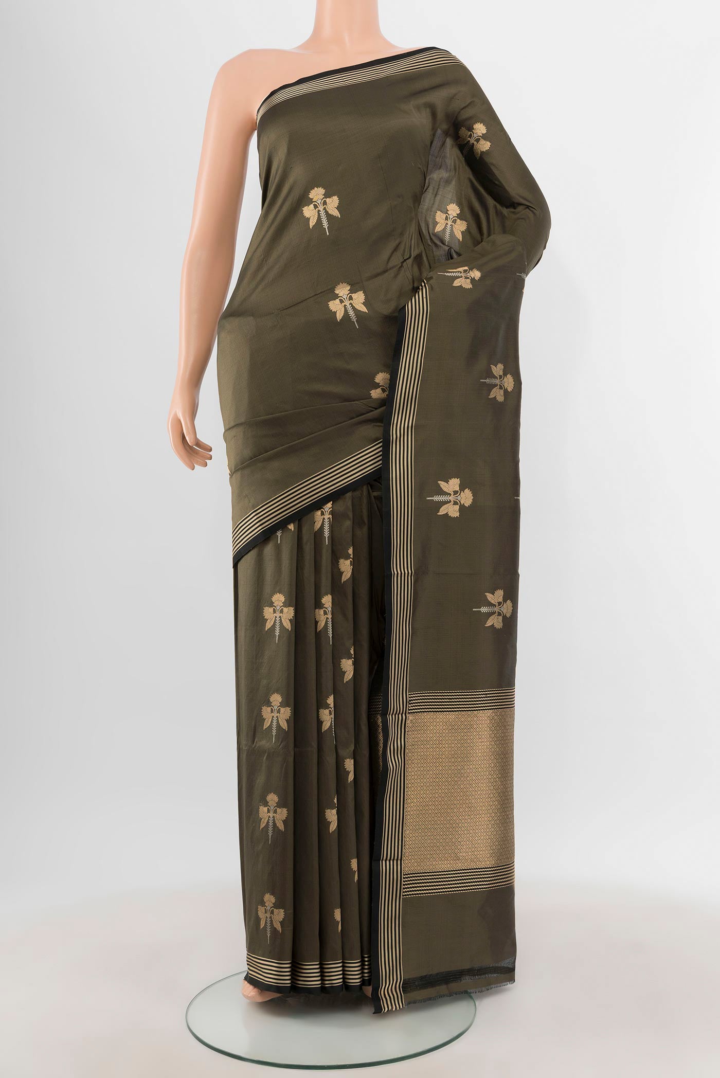 Olive Green Banarasi Katan Silk Saree with Zari Butta on the body and Thin Zari Line.  displayed on a mannequin