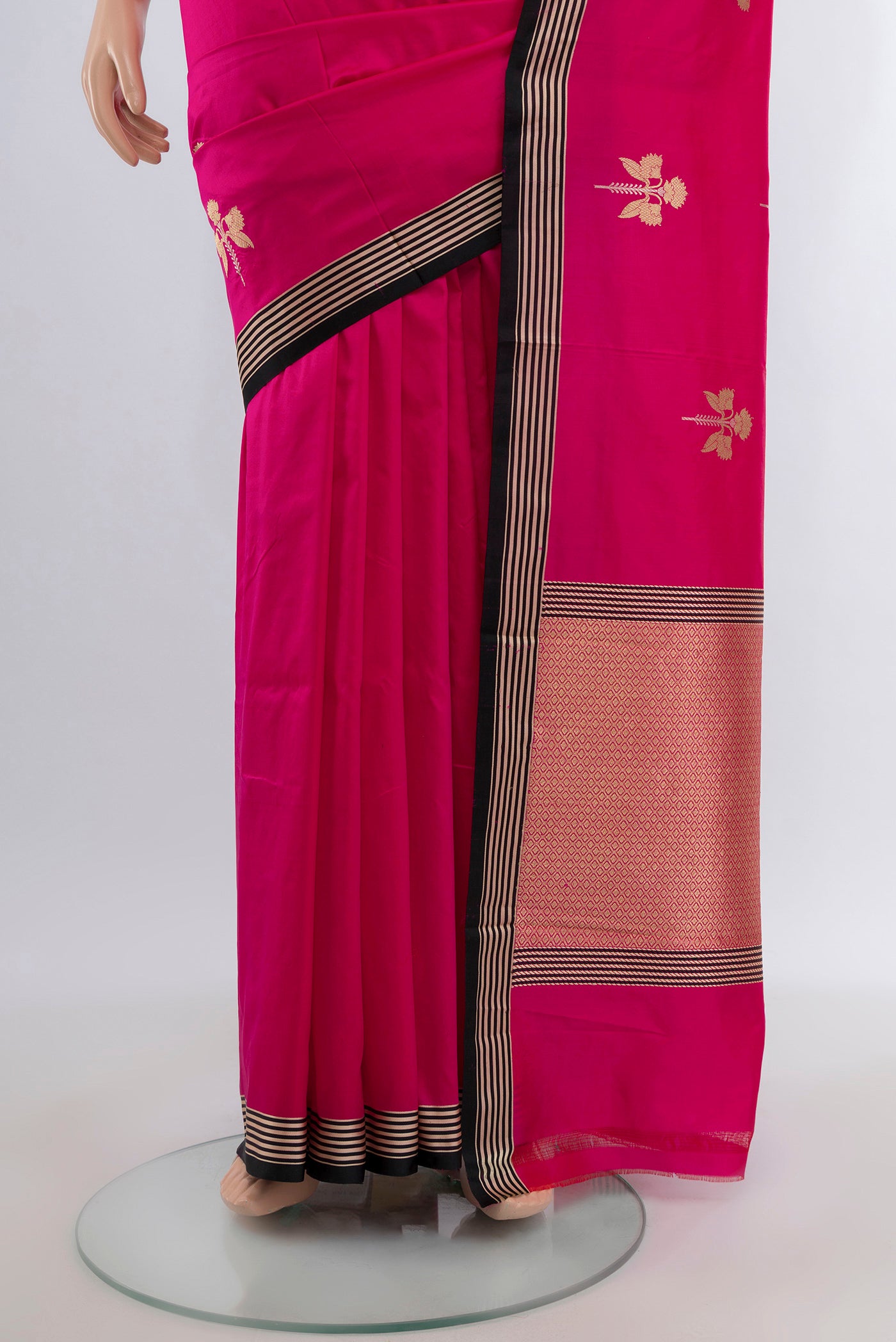 Pleats and pallu of Rani Pink Banarasi Katan Silk Saree with Zari Butta on the body and Temple Border. 