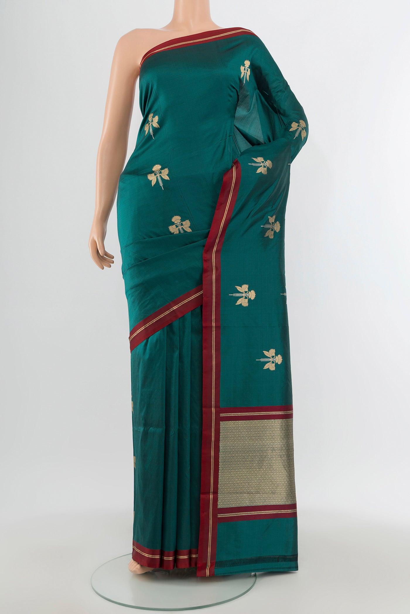 Teal Banarasi Katan Silk Saree with Zari Butta on the body and Plain Border.  displayed on a mannequin