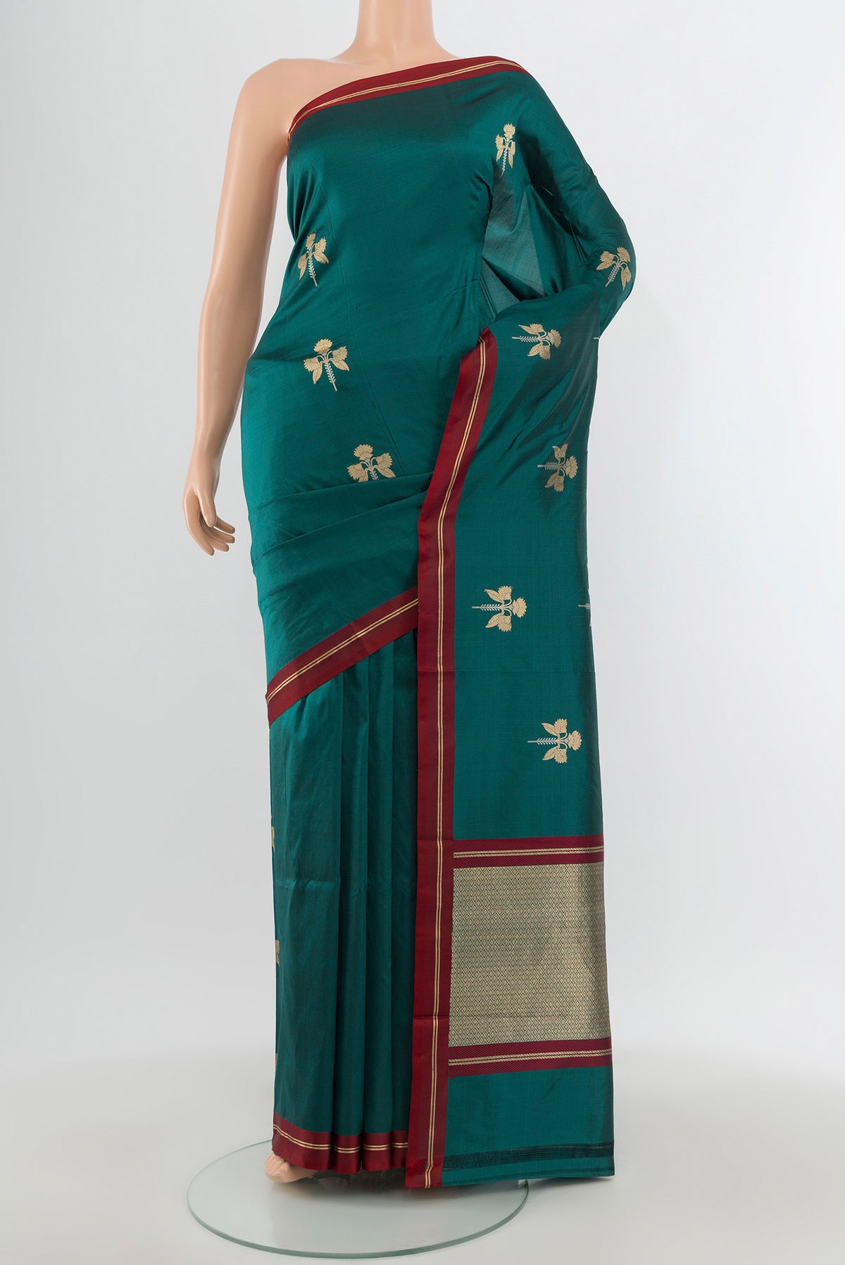 Teal Banarasi Katan Silk Saree with Zari Butta on the body and Plain Border.  displayed on a mannequin
